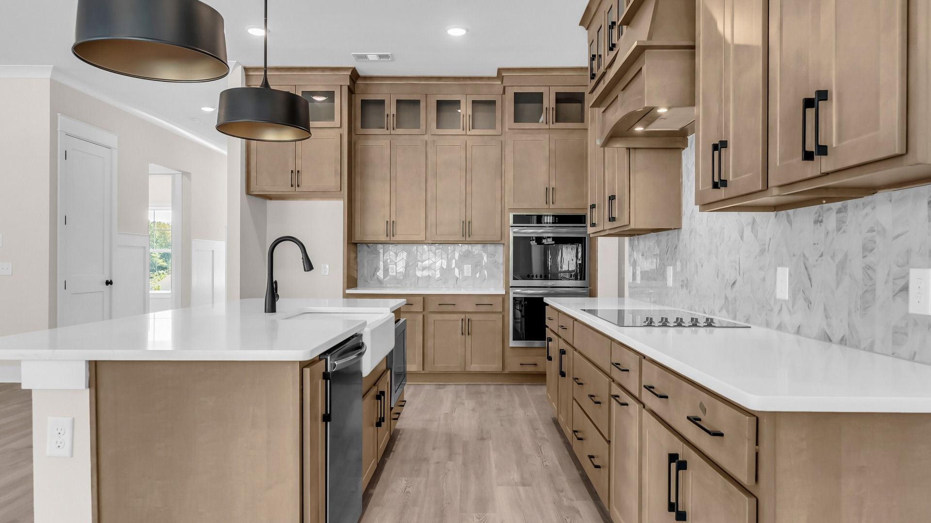 Gorgeous kitchen finishes with tile backsplash, upgraded cabinets, and quartz countertops