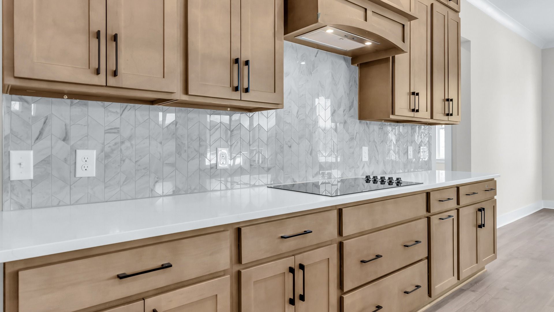 Gorgeous kitchen finishes with tile backsplash, upgraded cabinets, and quartz countertops