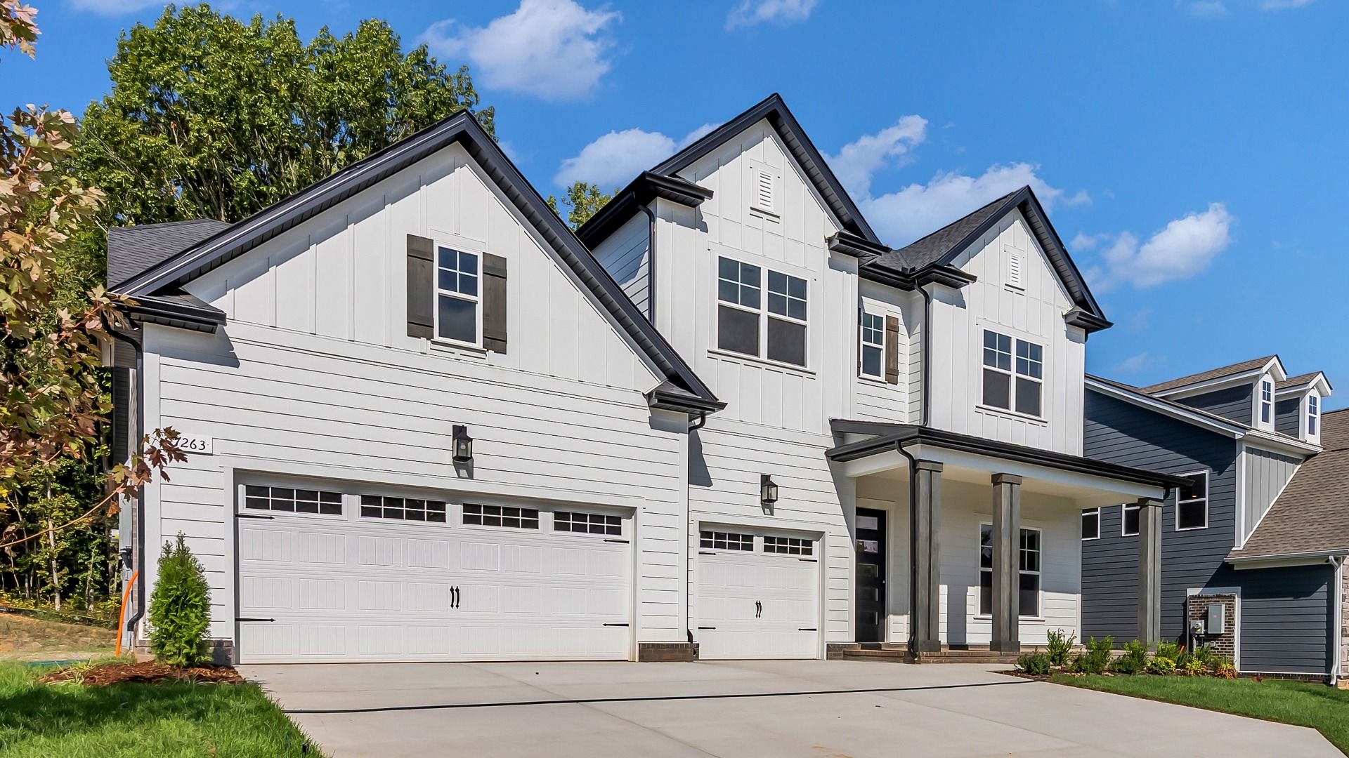 Front Exterior of Home with 3-car garage and overed front porch (Representative of completed home)
