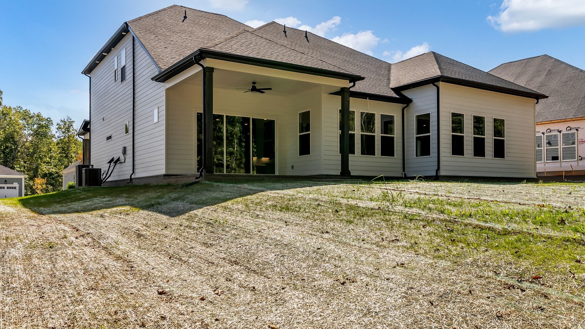 Exterior of home with covered rear porch (Representative of finished home)