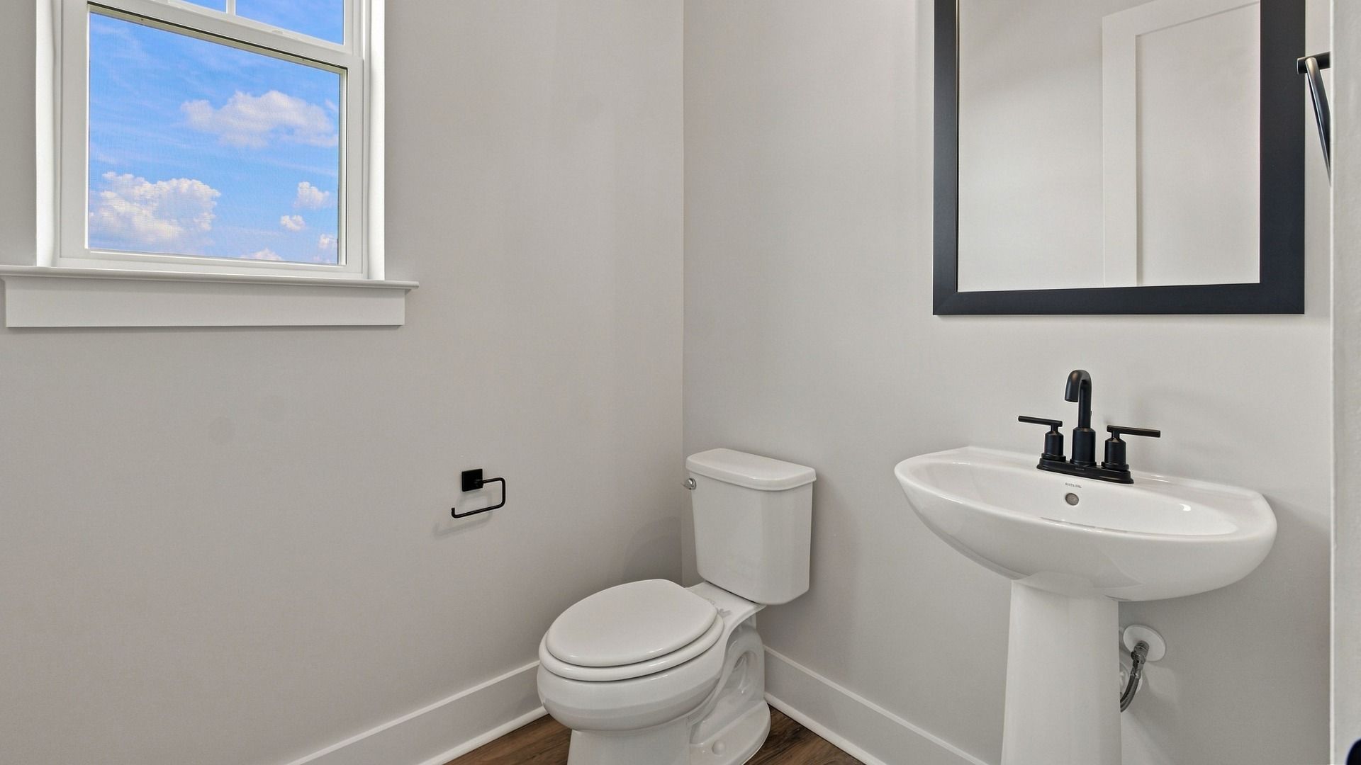 Classic half bathroom for downstairs area with side window.