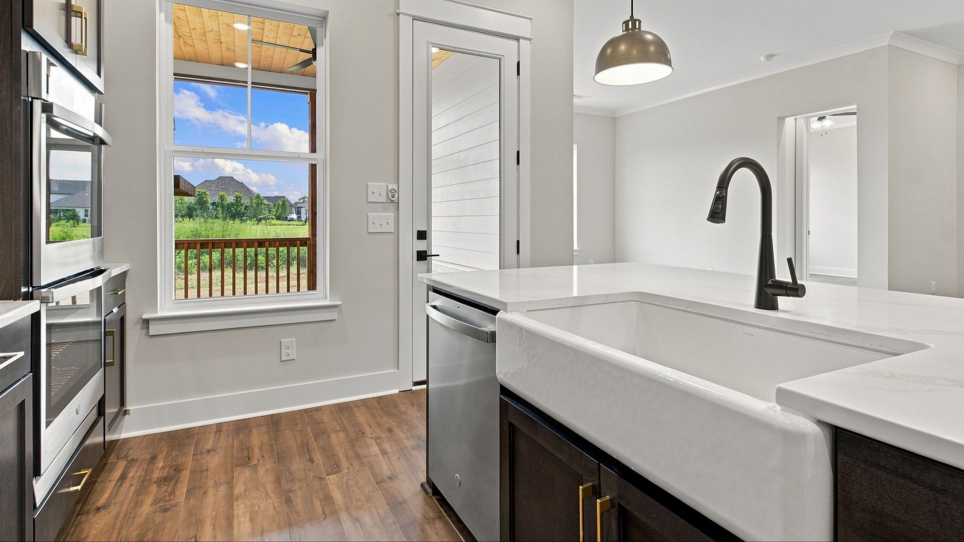 Sink and dishwasher next to backyard door.