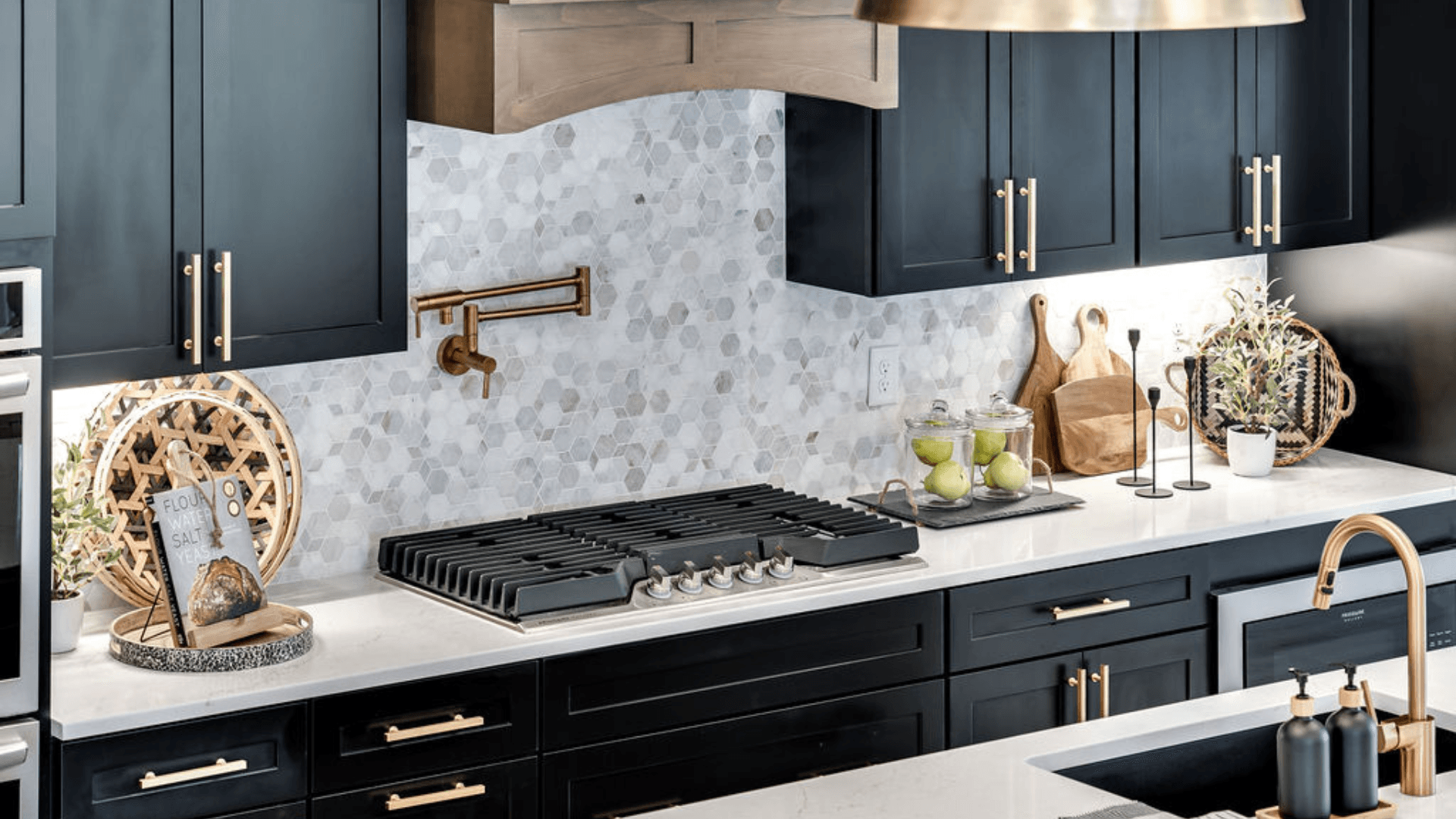 Kitchen essential stove with black cabinets and grey backsplash with countertop spacing for other kitchen utensials.