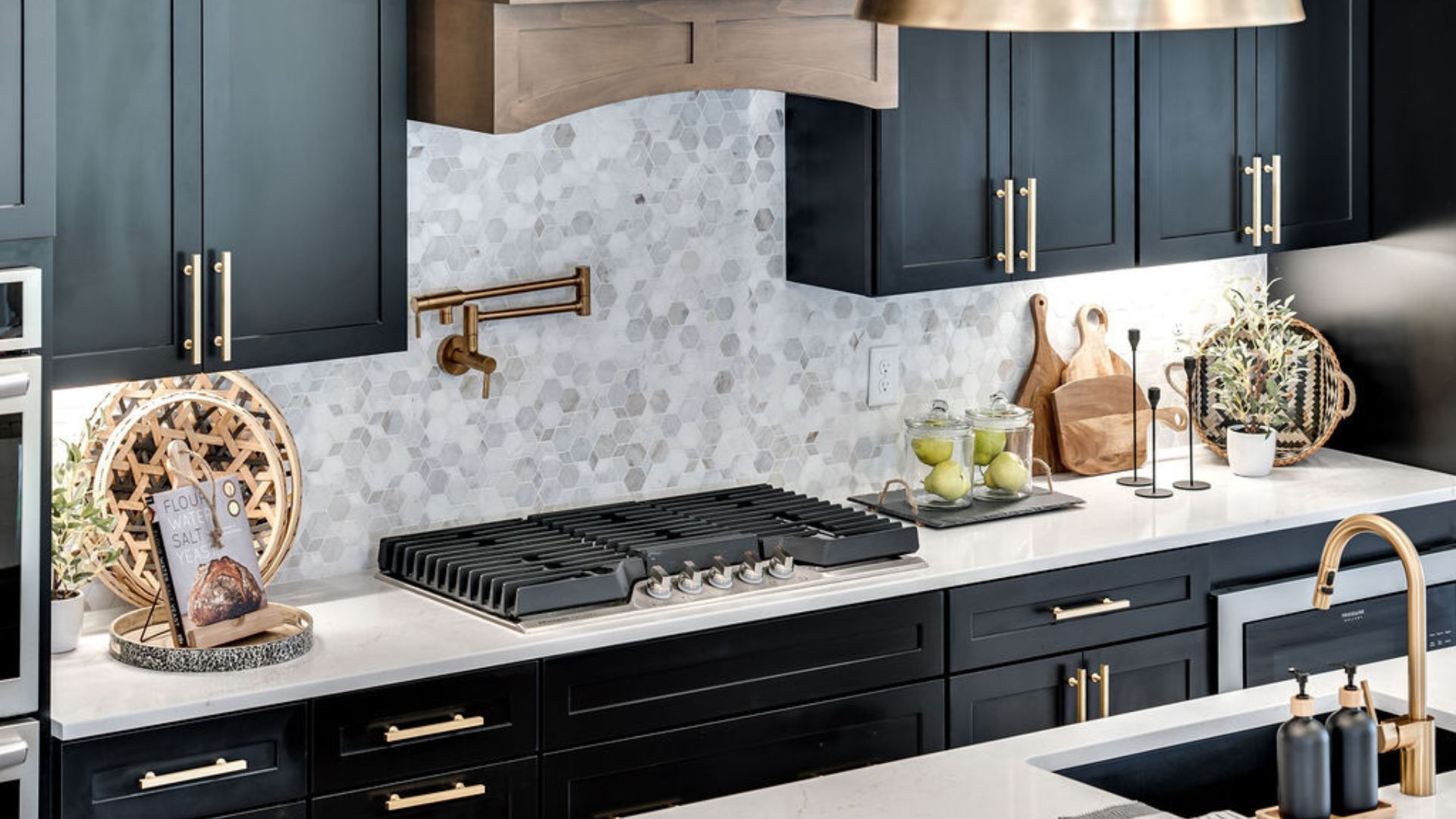 Kitchen essential stove with black cabinets and grey backsplash with countertop spacing for other kitchen utensials.