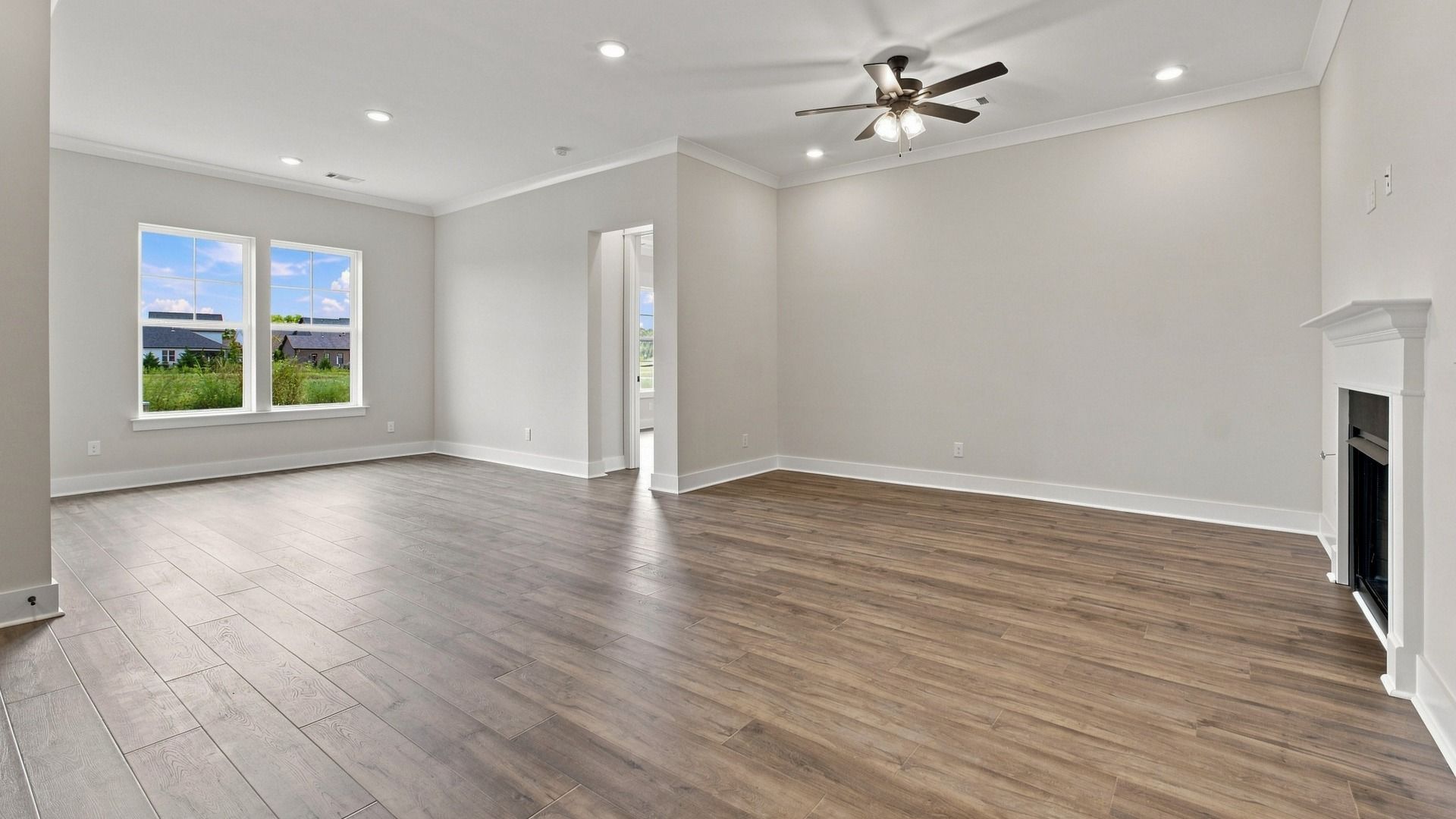 Natural light spills in from the window int the main living space featuring elevated fireplace feature.