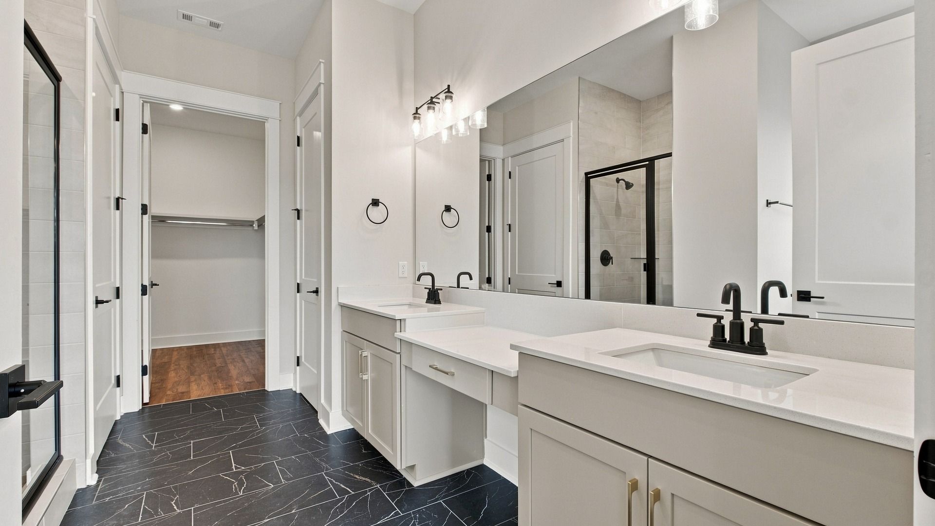 Elevated style bathroom with large mirror and dual vanity/sinks.