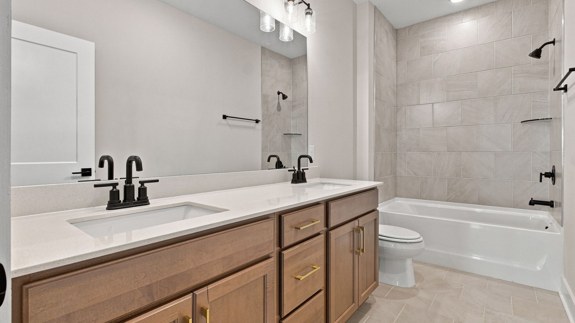 Larger upstairs bathroom featuring dual sinks as well as a bathtub.