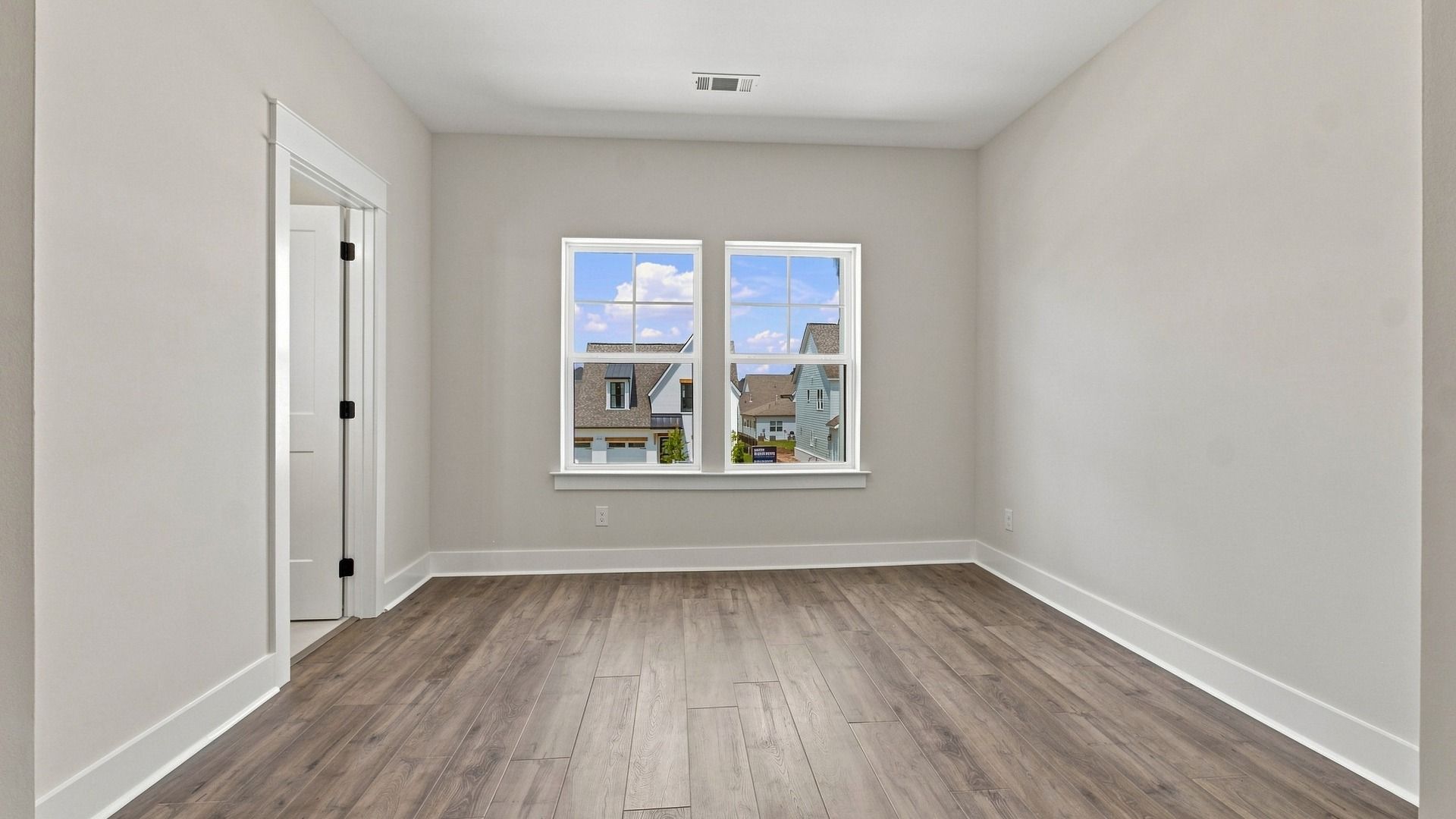Secondary Bedroom with hard surface flooring and windows