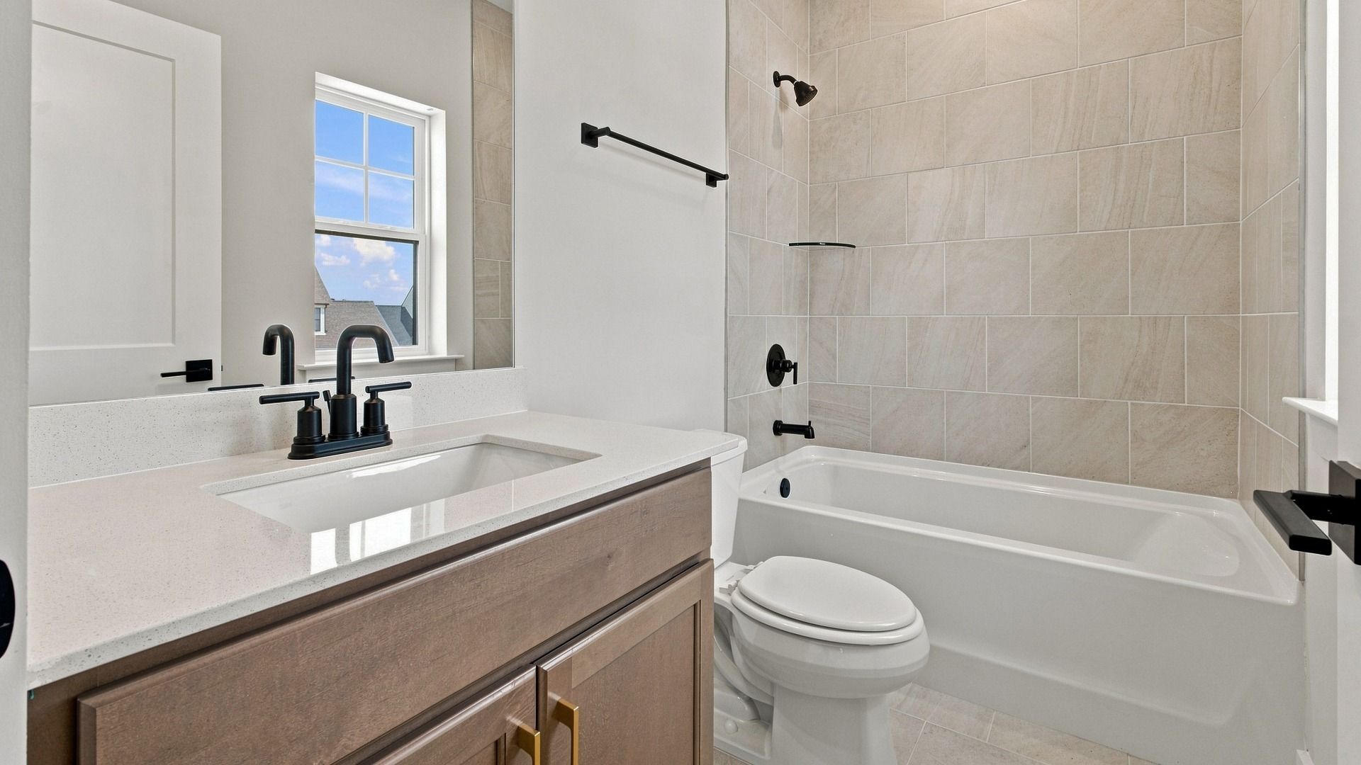 Upstairs bathroom connected to bedroom with bathtub and window for natural light.
