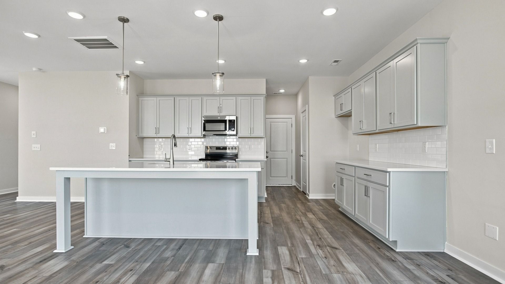 View of kitchen showcasing modern light fixtures for superb cooking and dining experiences