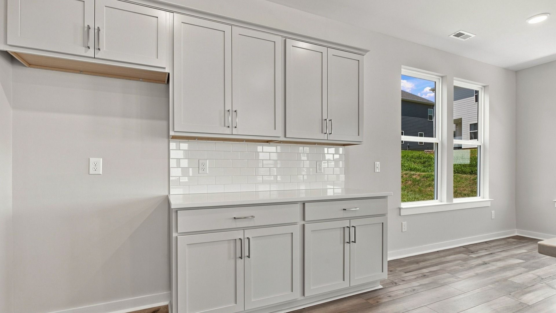 Open space for refrigerator combined with elevated touch of white quartz backsplash