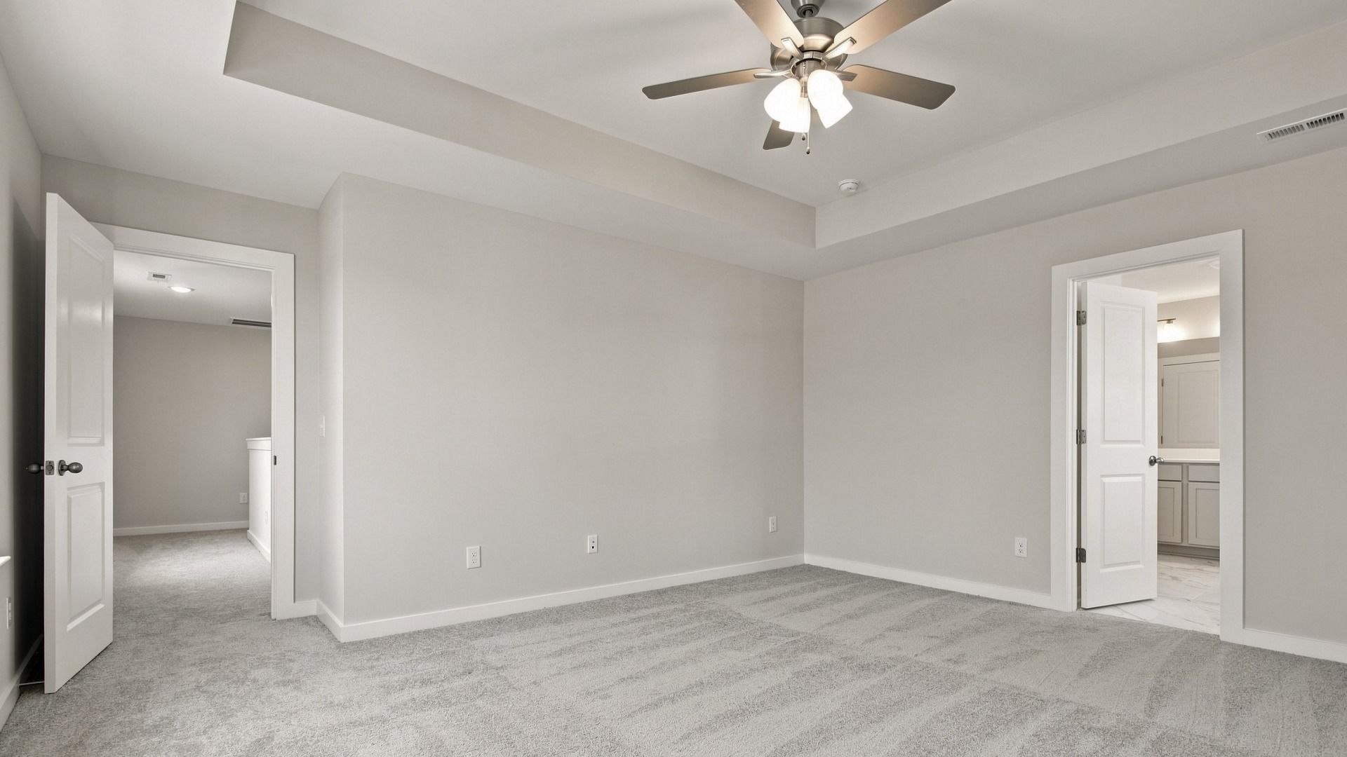 Angled view of bedroom showing connected bathroom across from room entrance