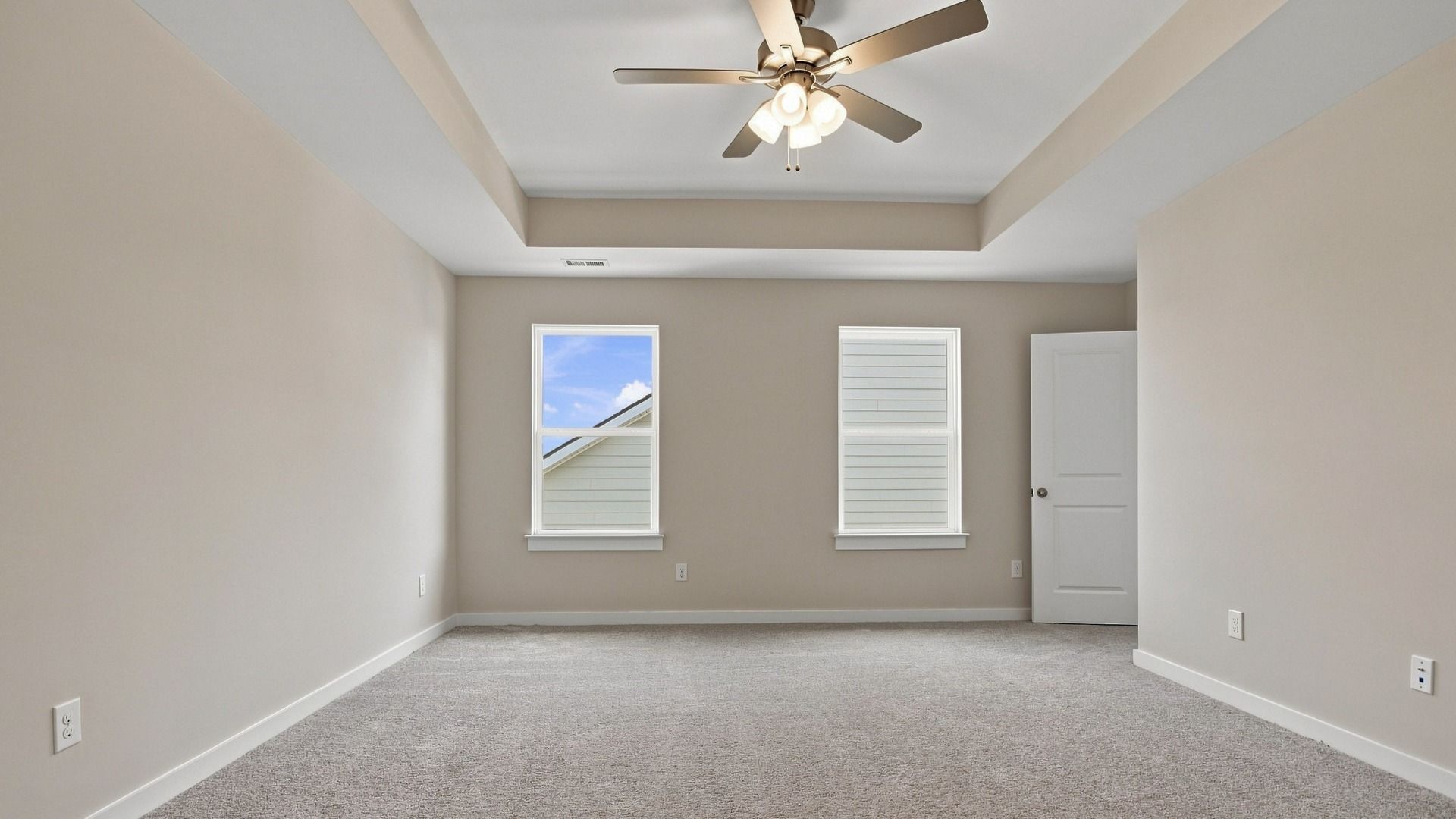 View from connected bathroom showcasing two windows next to room entry