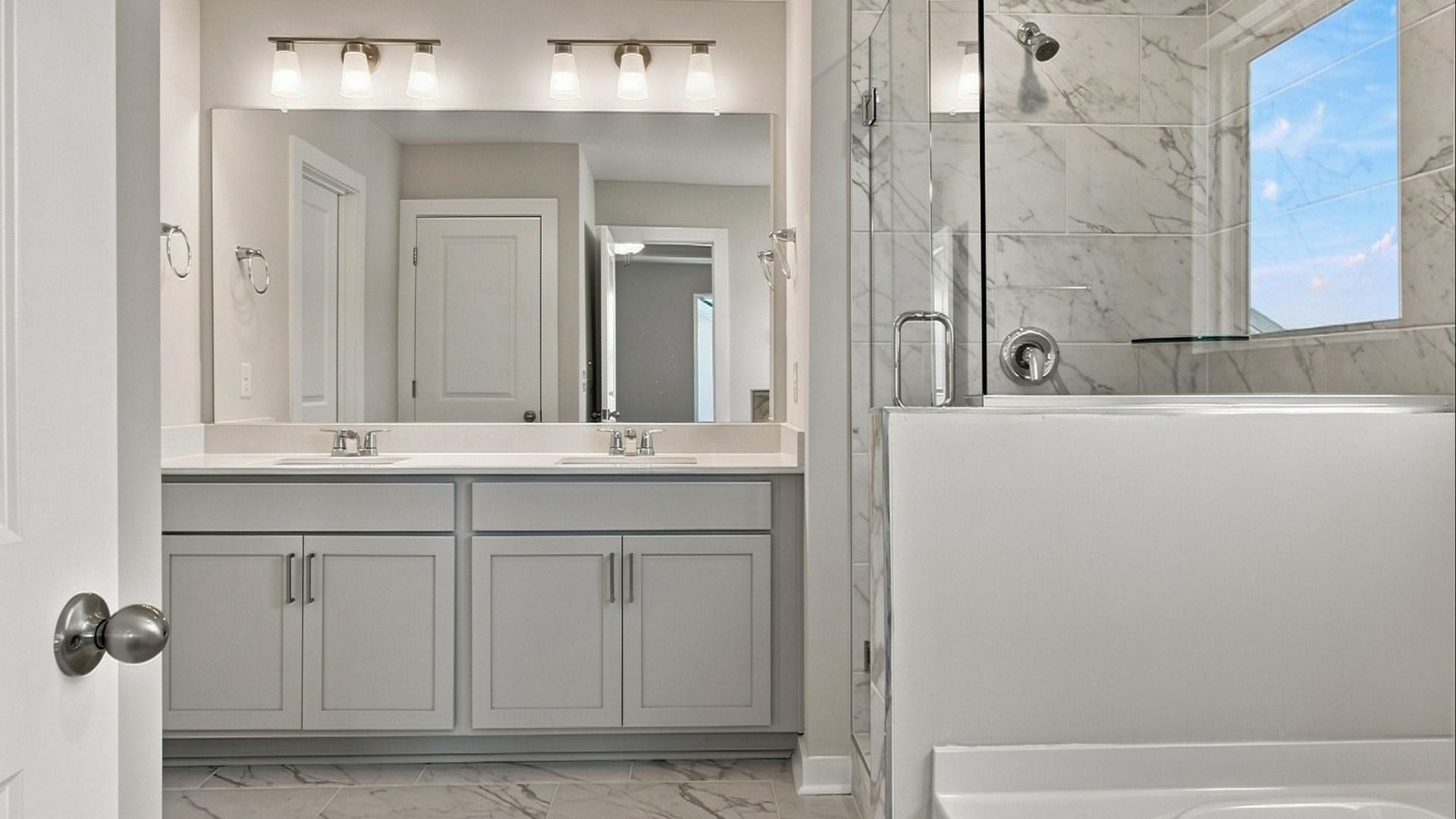 Relaxing bathroom features such as separate bathtub and shower paired with dual vanities