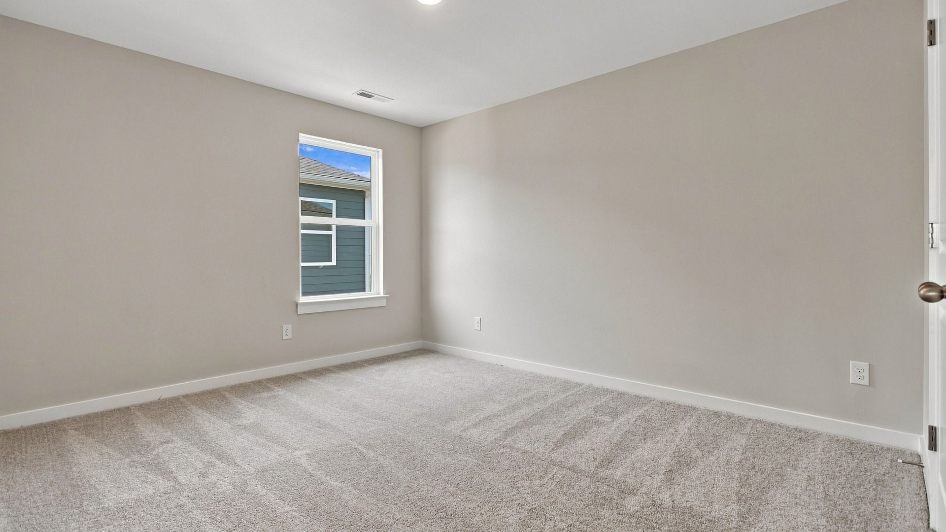 Other secondary bedroom with window across from closet and room entrance