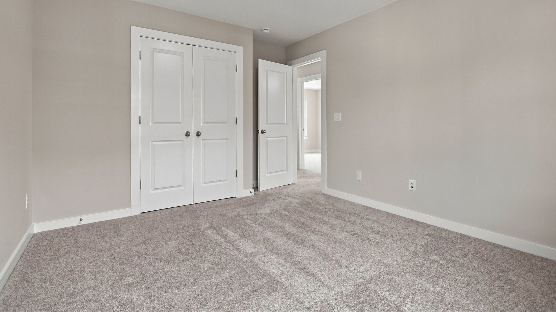 Convenient double door closet in secondary bedroom for storage space