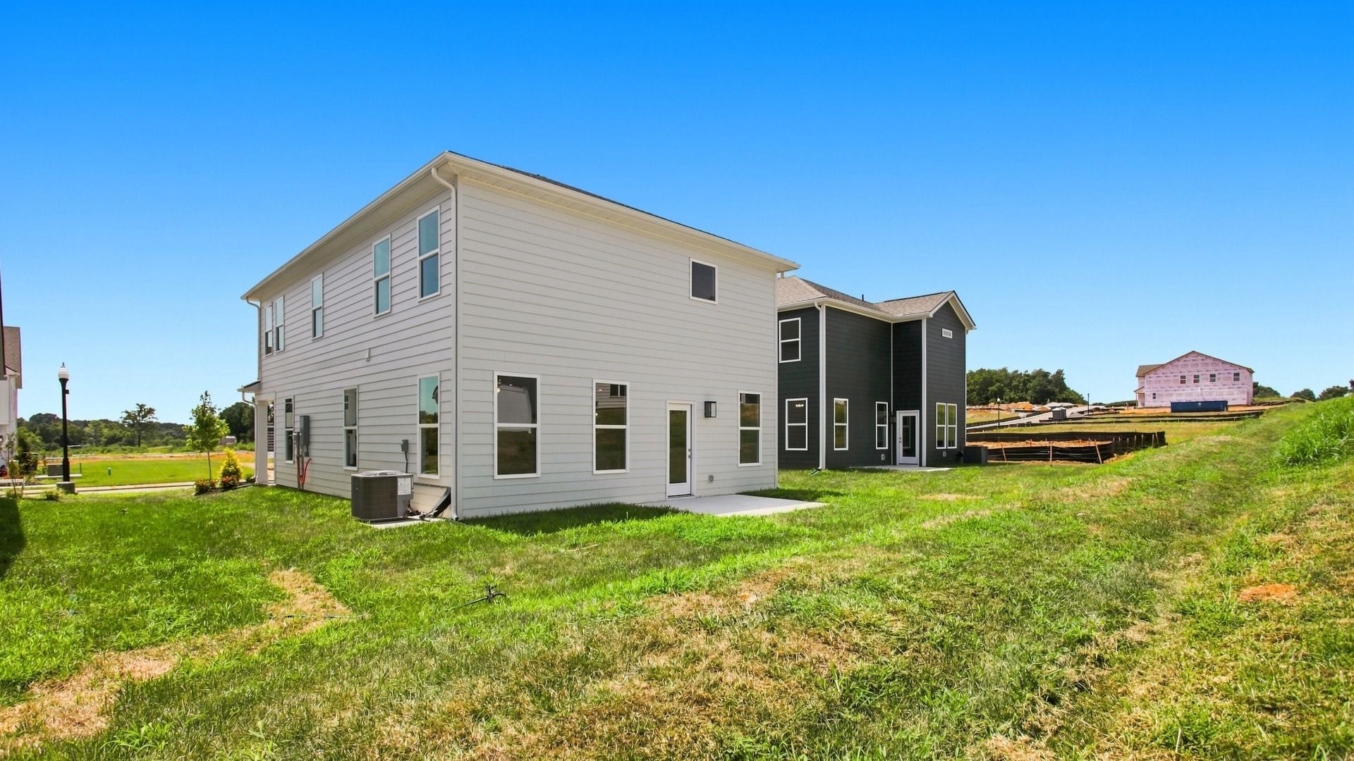 Angled view of spacious two-story home from backyard