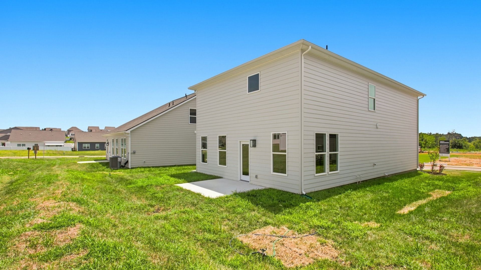 Angled exterior view of two-story home from backyard
