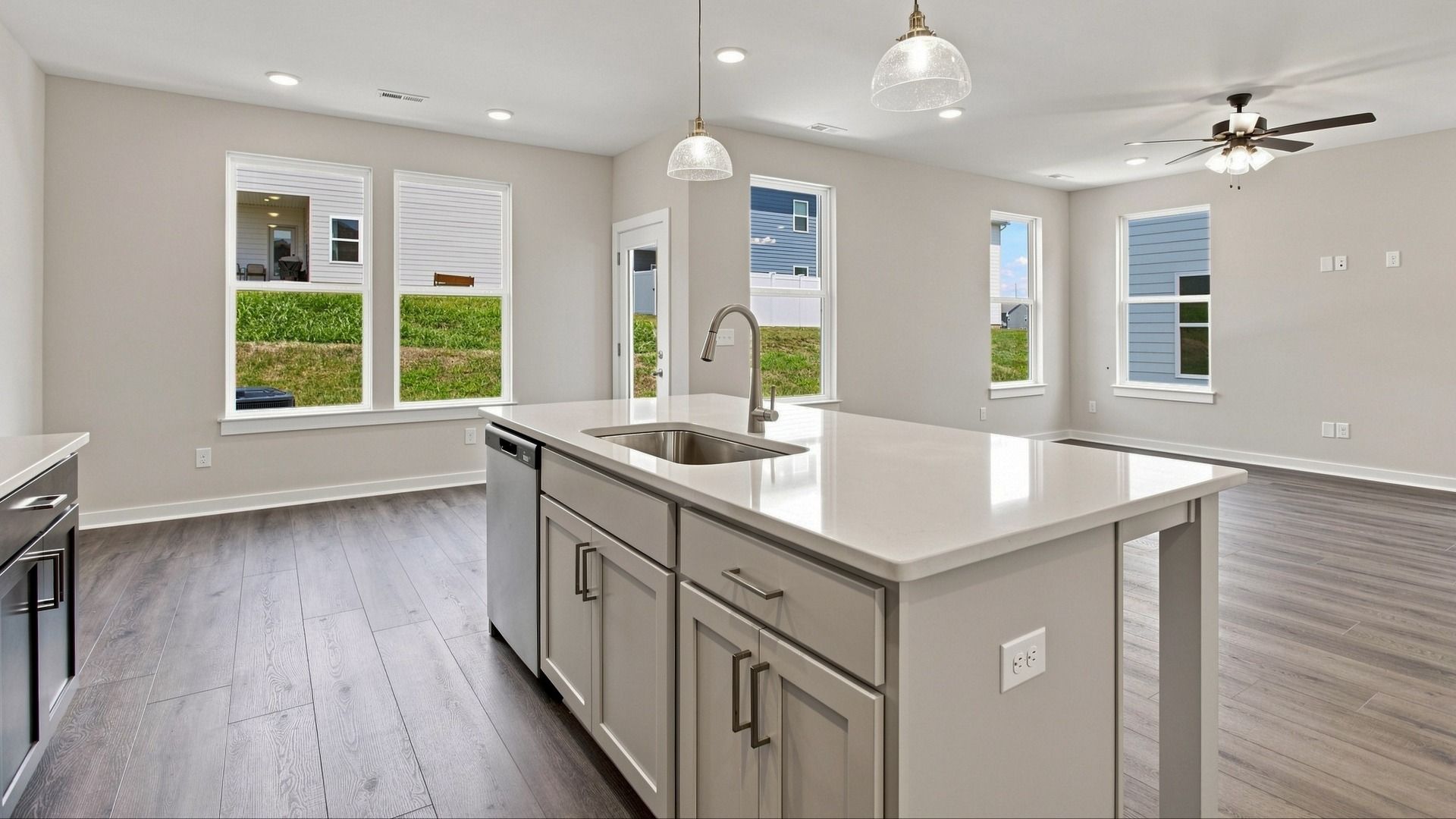 View of community and of kitchen island paired with essential sink and dishwasher