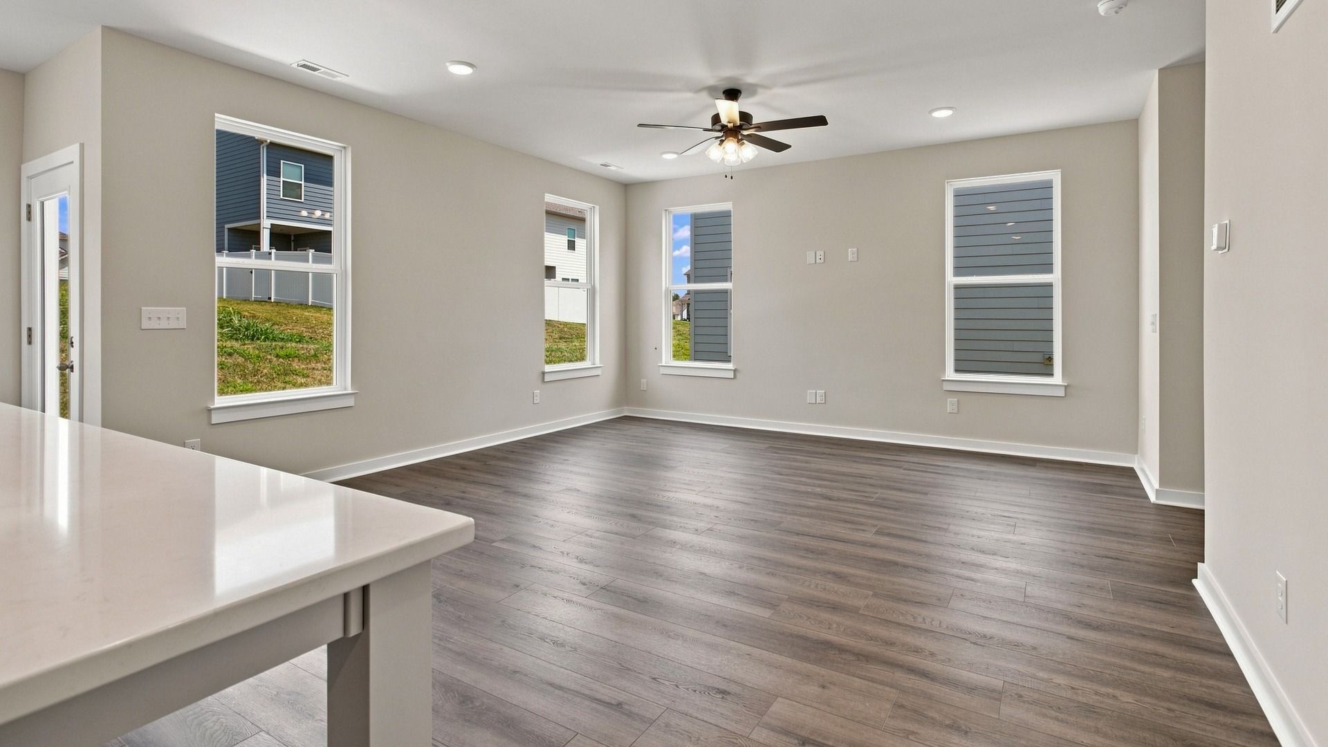 Versatile living space with various windows and backdoor access