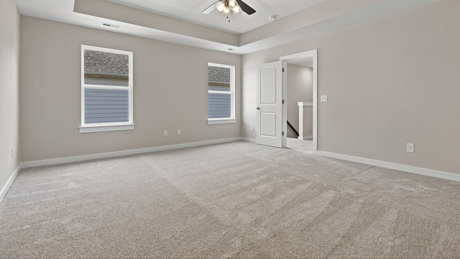 View of room entryway accompanied by natural light flooding in from windows
