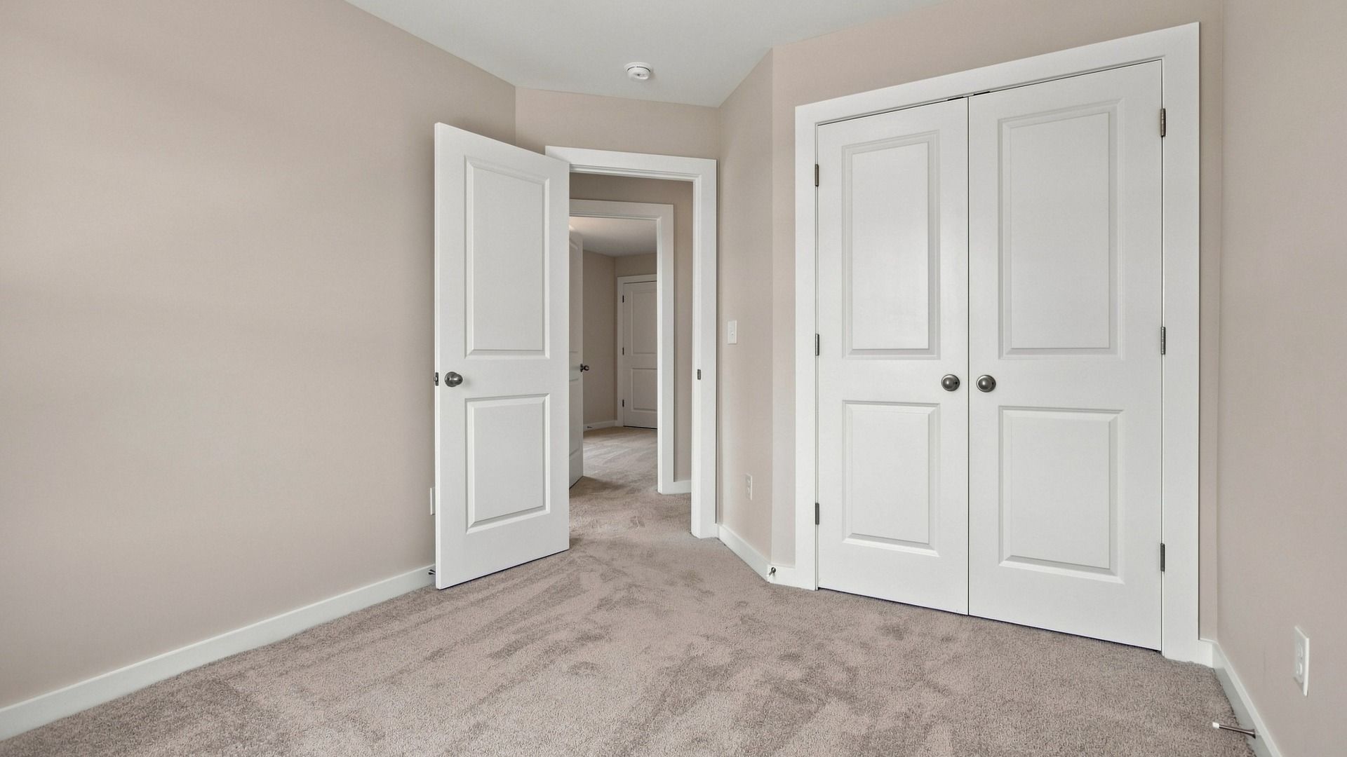 View of secondary entrance next to doubled door closet