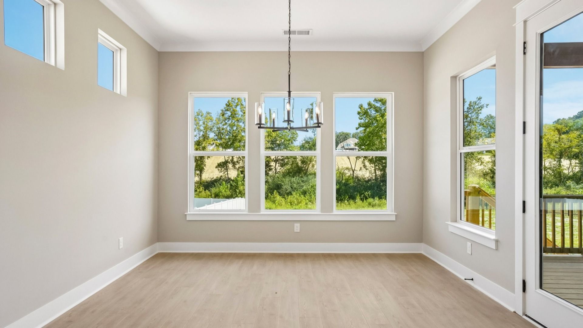 Dining area with hanging light next to backyard door
