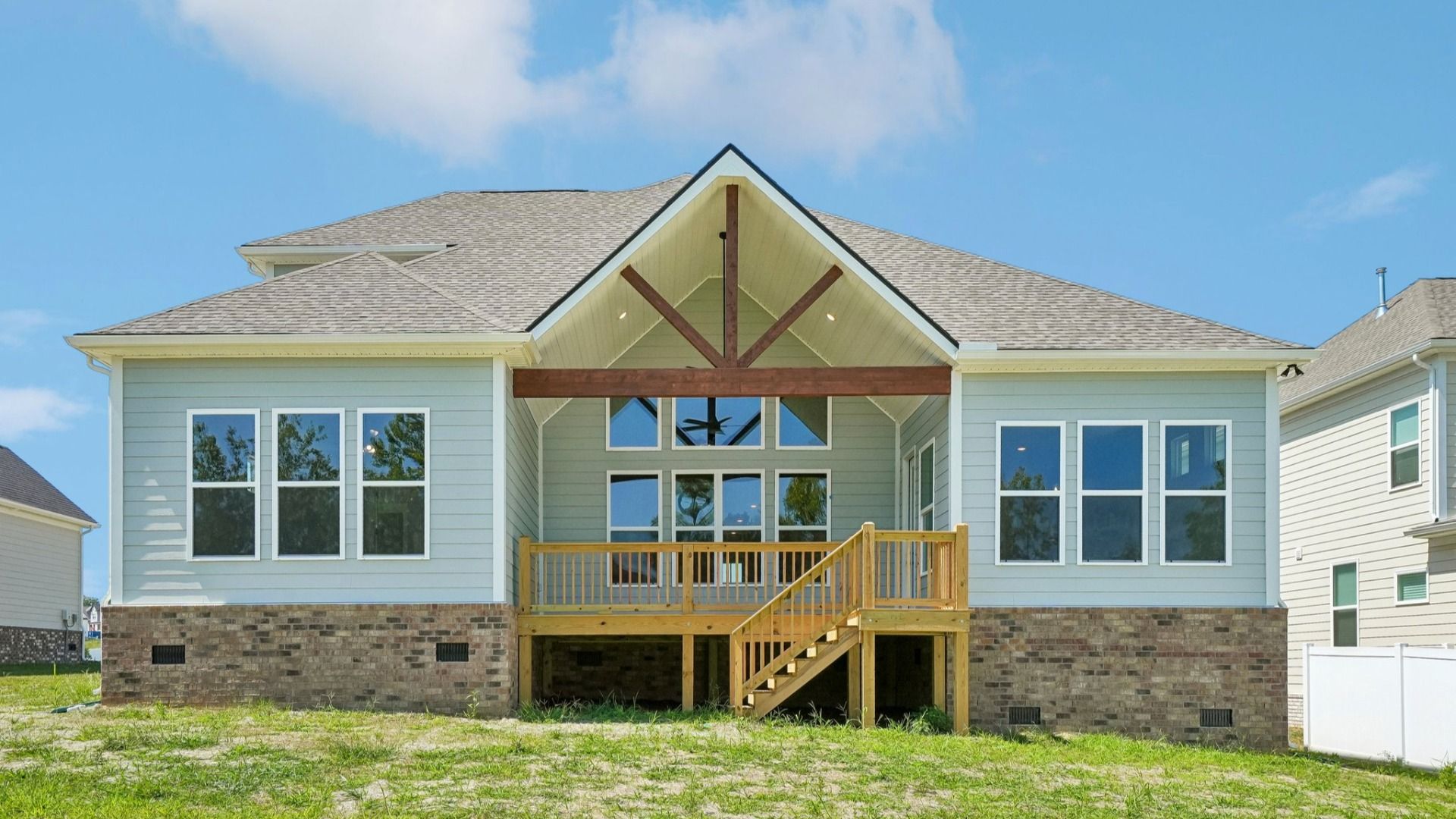 Rear exterior view of two-story home featuring a backyard porch