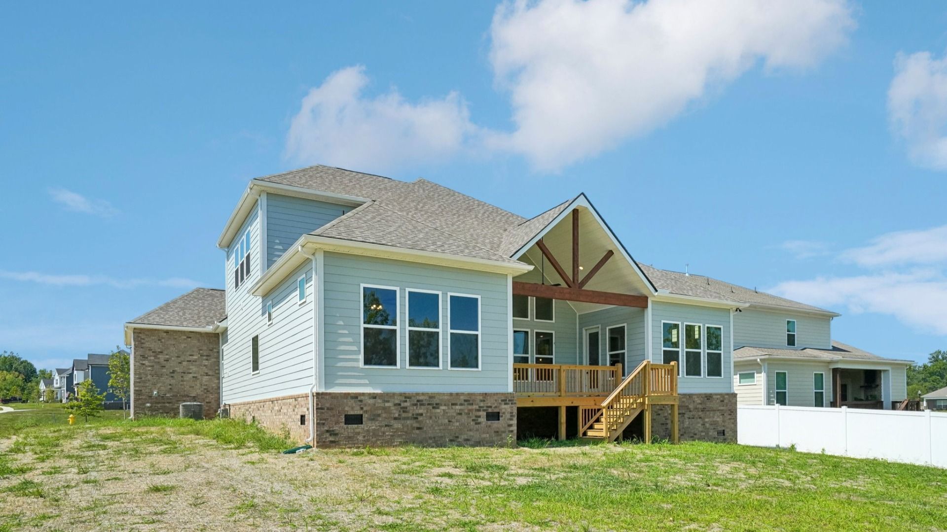 Rear exterior view of two-story home featuring a backyard porch