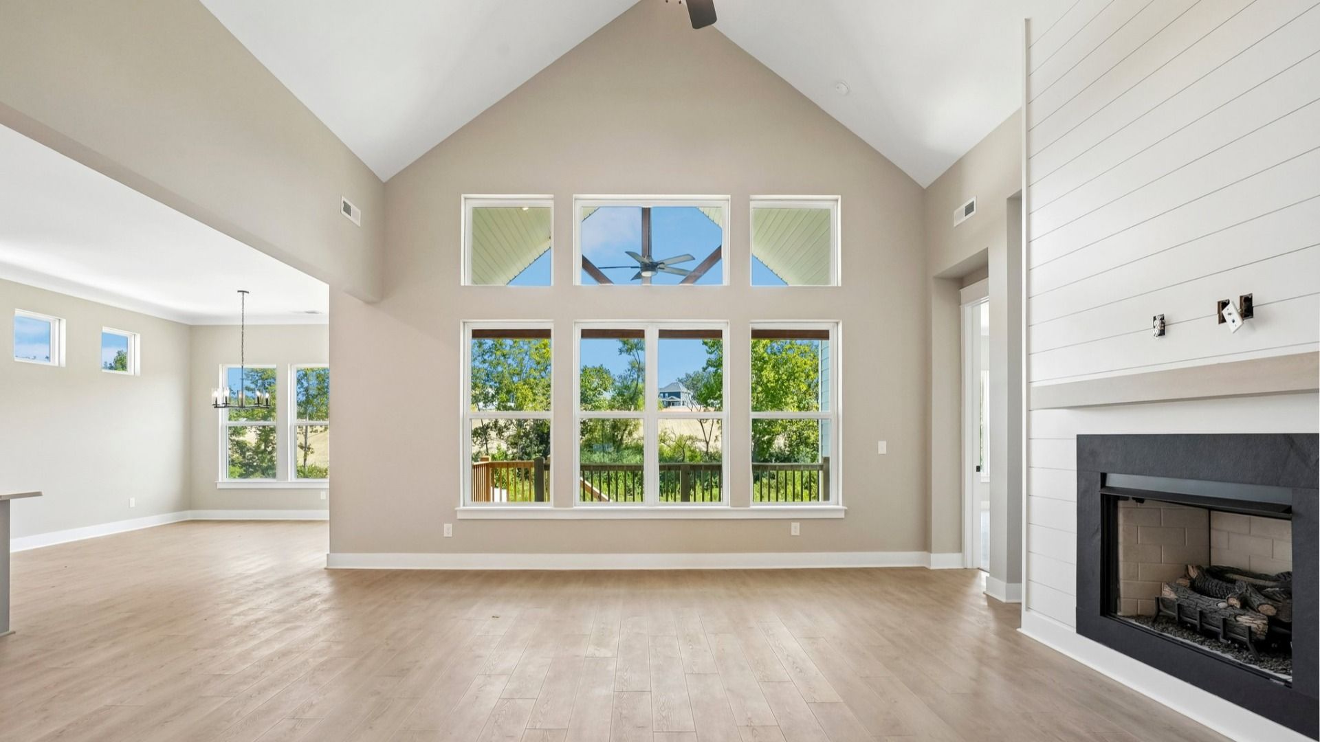 Elevated living space with various windows and fireplace