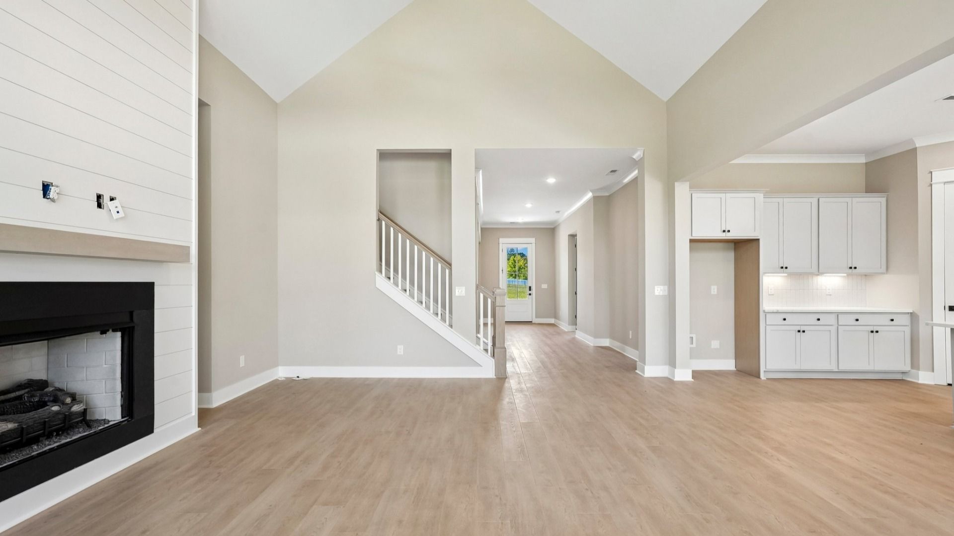 High ceilings for a spacious feel combined with elevated features such as hardwood flooring and fireplace