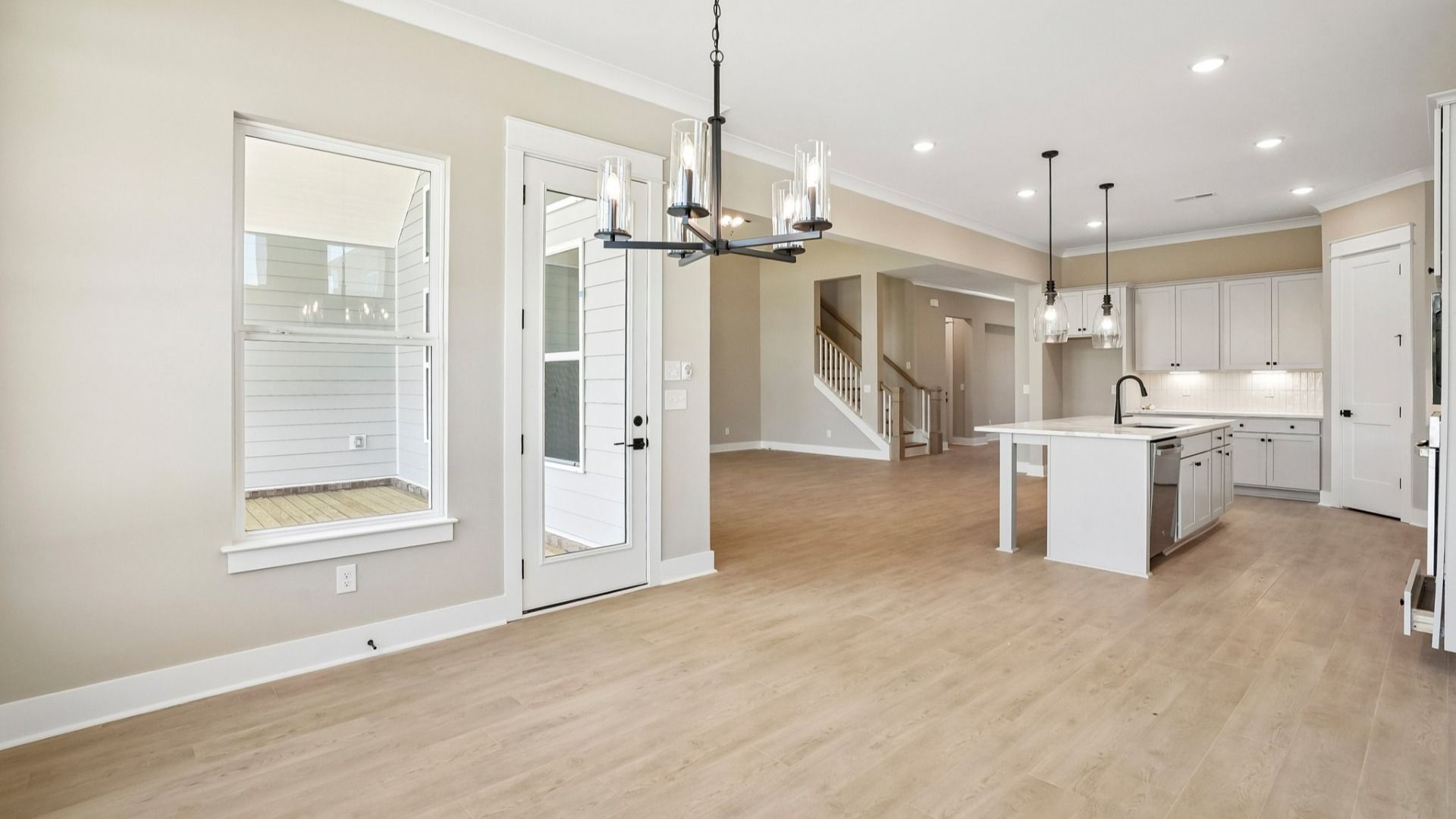 View of dining area and kitchen from back windows