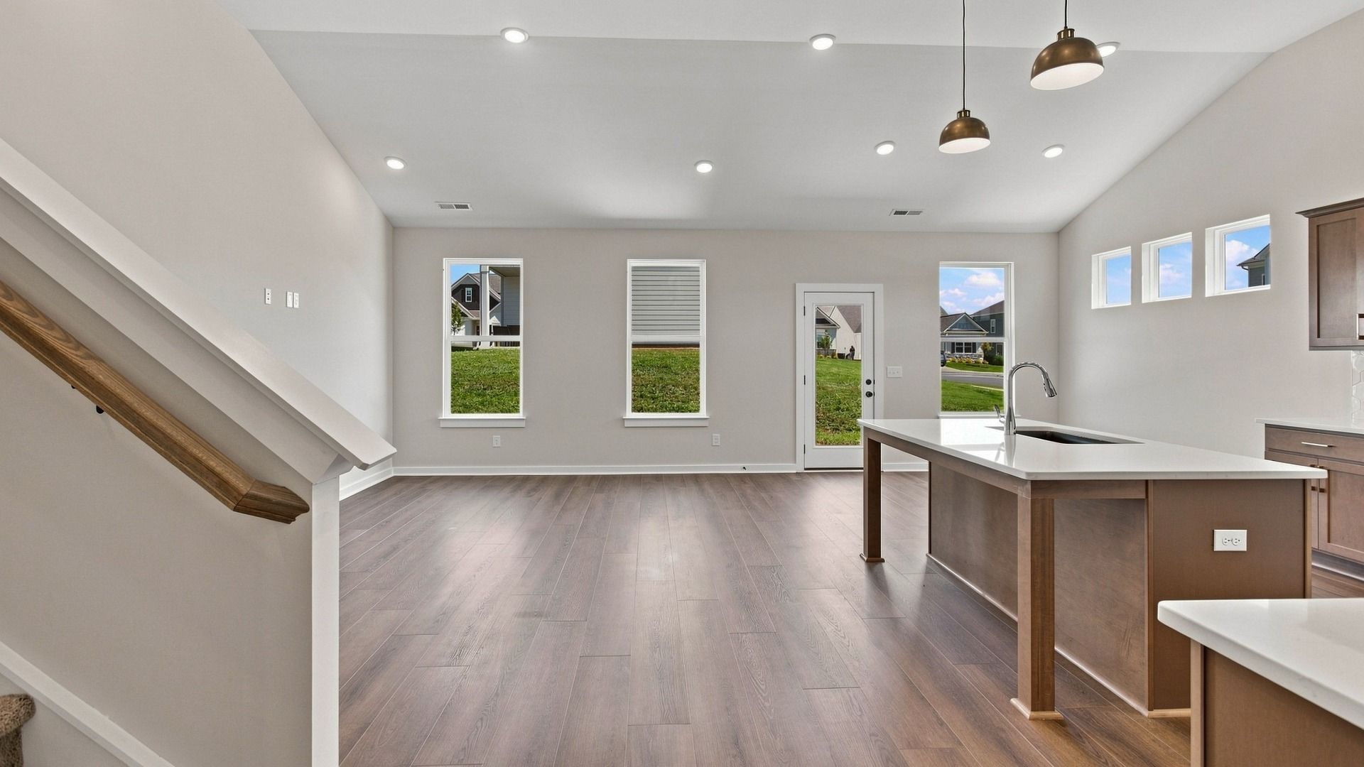 Open concept first floor with kitchen, dining, and living room areas