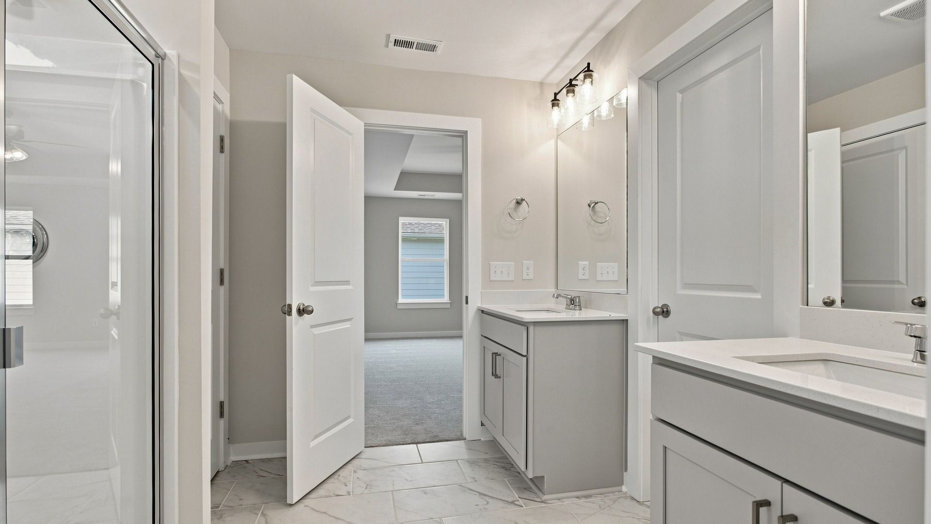 Bathroom with two vanities and large tiled shower