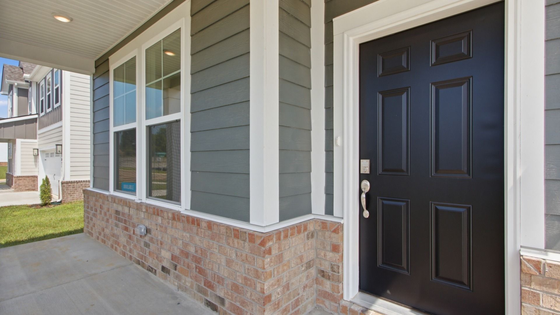 Close up of beautiful black front door underneath front porch