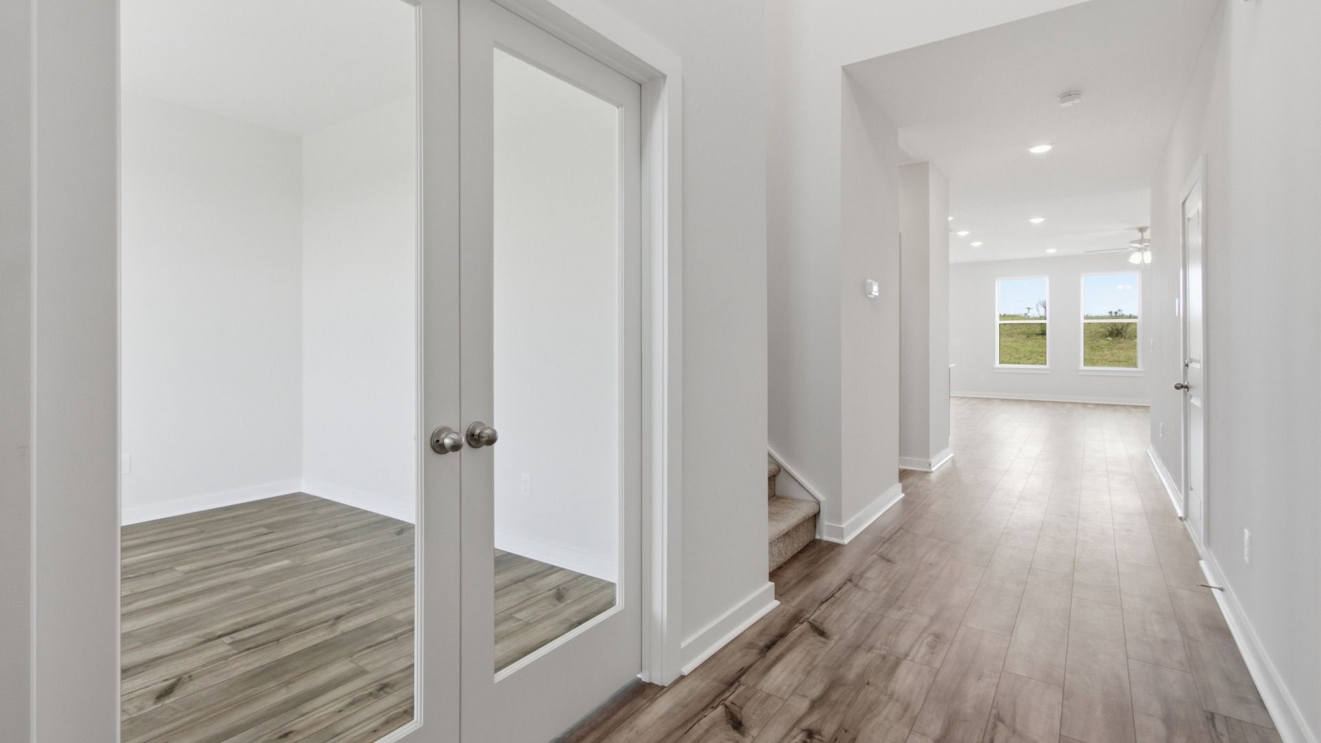 Clear double doors for versatile front room next to staircase as you enter the home