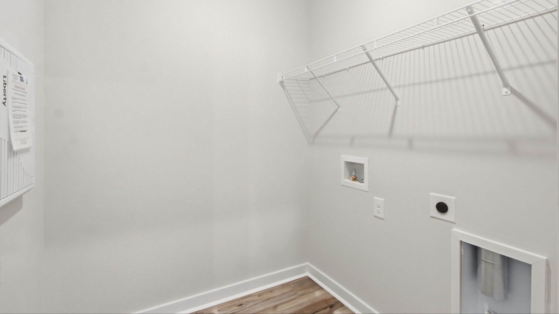 Laundry room with racks above for storage space options