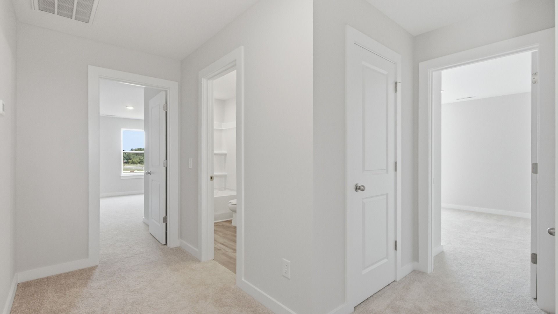 Hallway showcasing several rooms and bathroom
