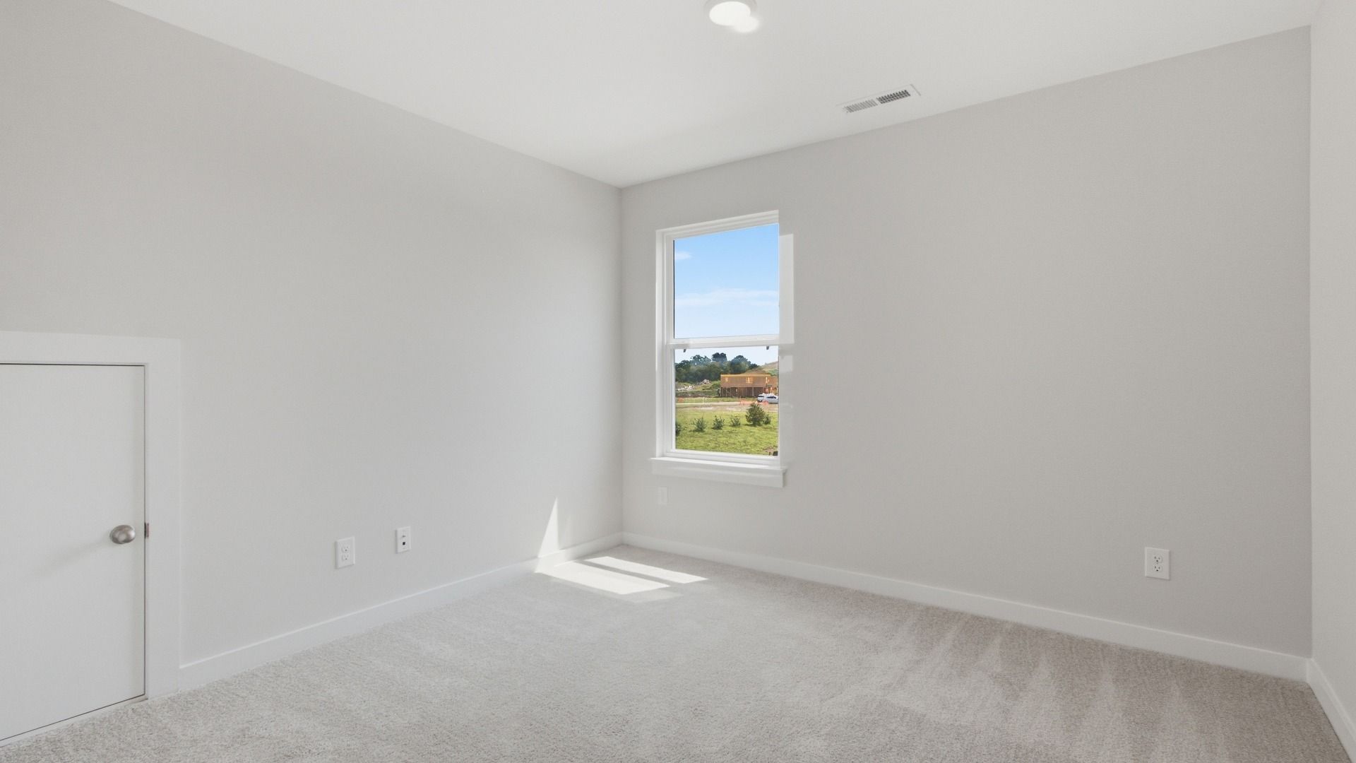 Separate secondary bedroom with window and small door for storage