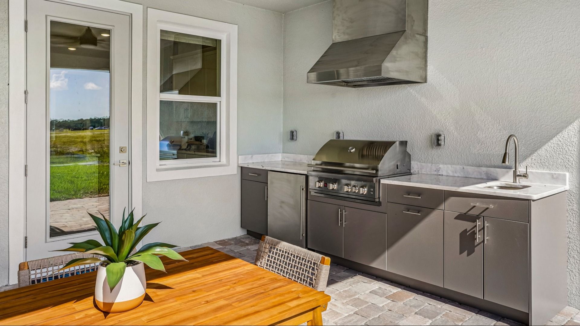 Oleander Rear Lanai with a Summer Kitchen by DRB Homes in Ardisia Park in New Smyrna Beach, FL