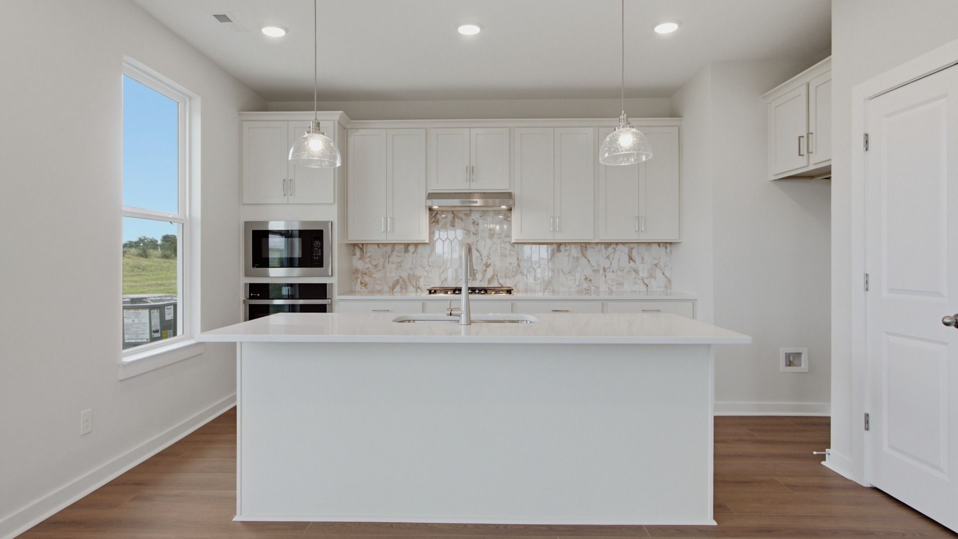 Kitchen with island and convenient pantry door