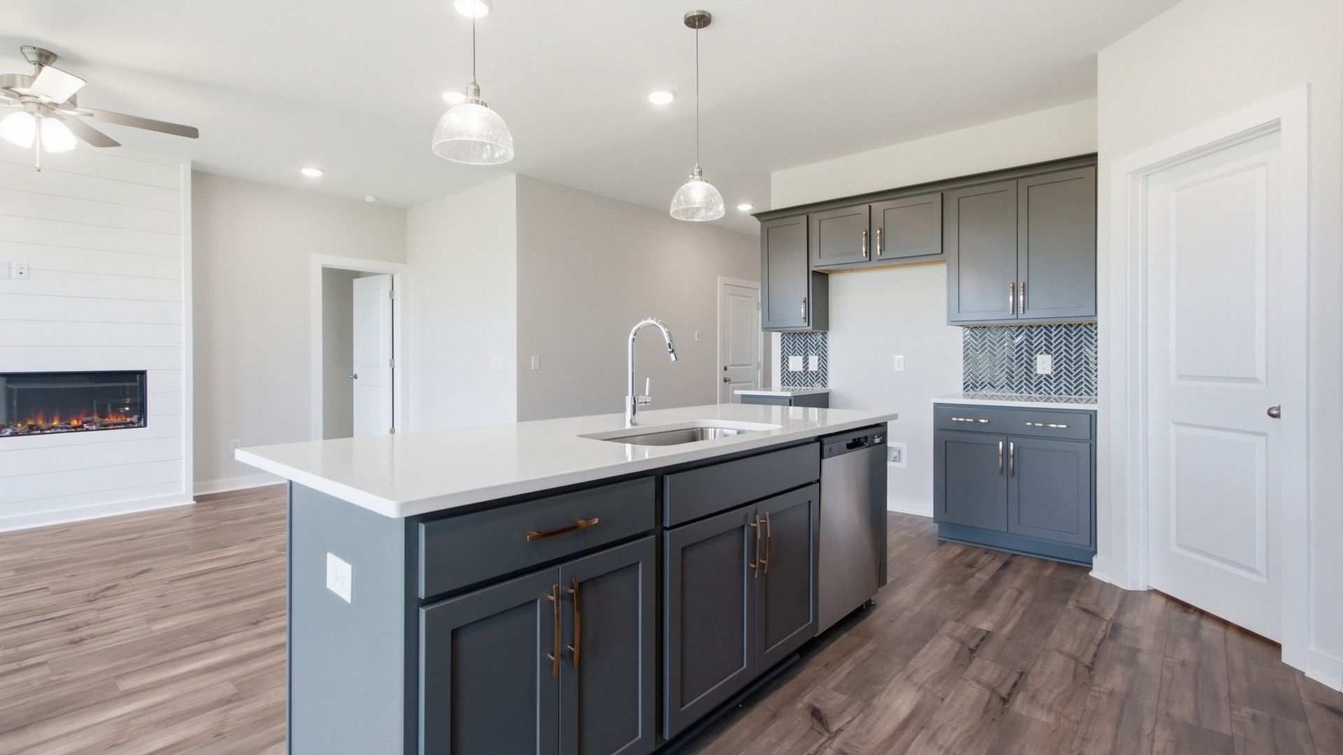 Kitchen with corner pantry and island, with living room fireplace nearby