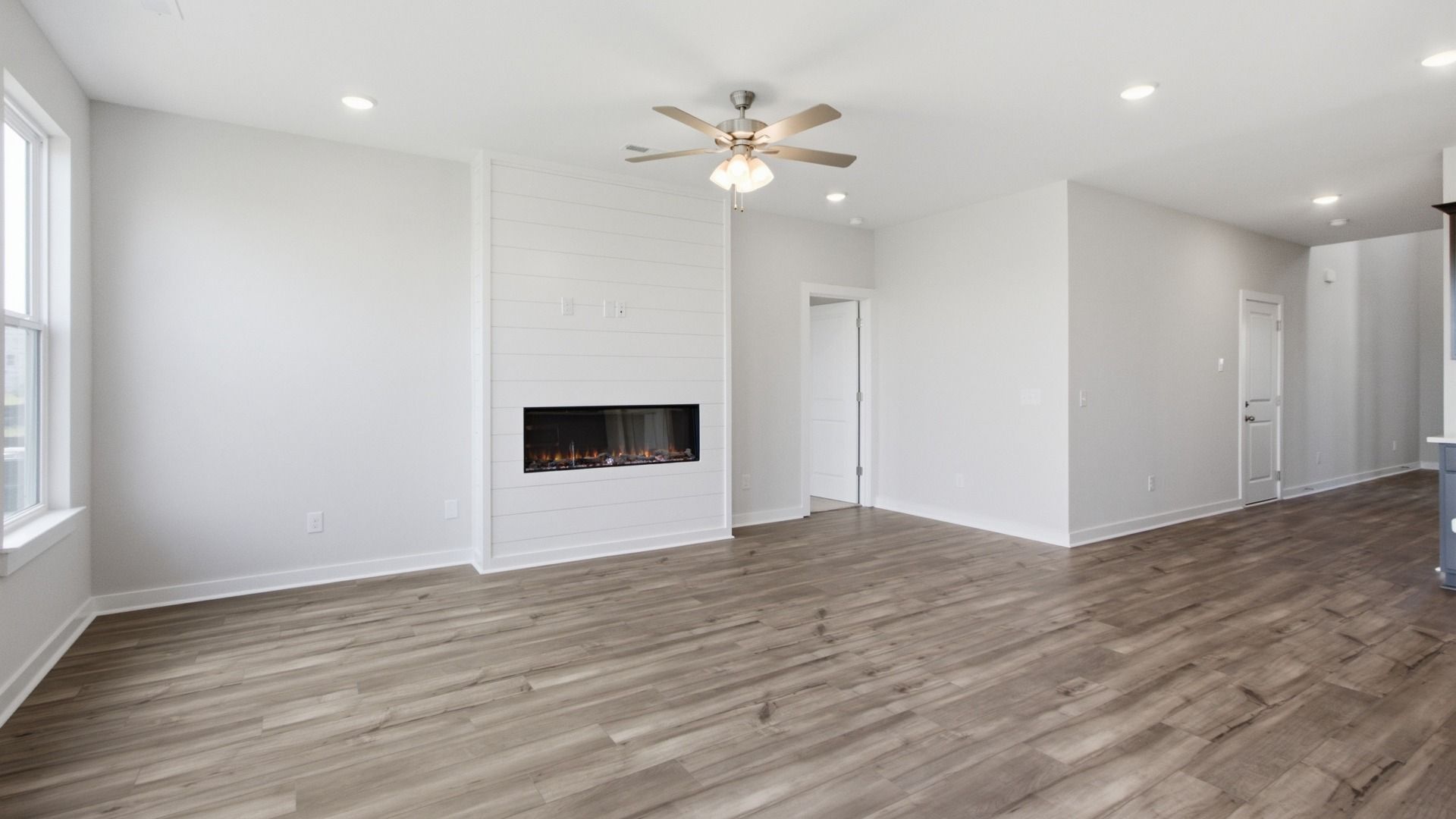 Cozy living room centered around shiplap fireplace