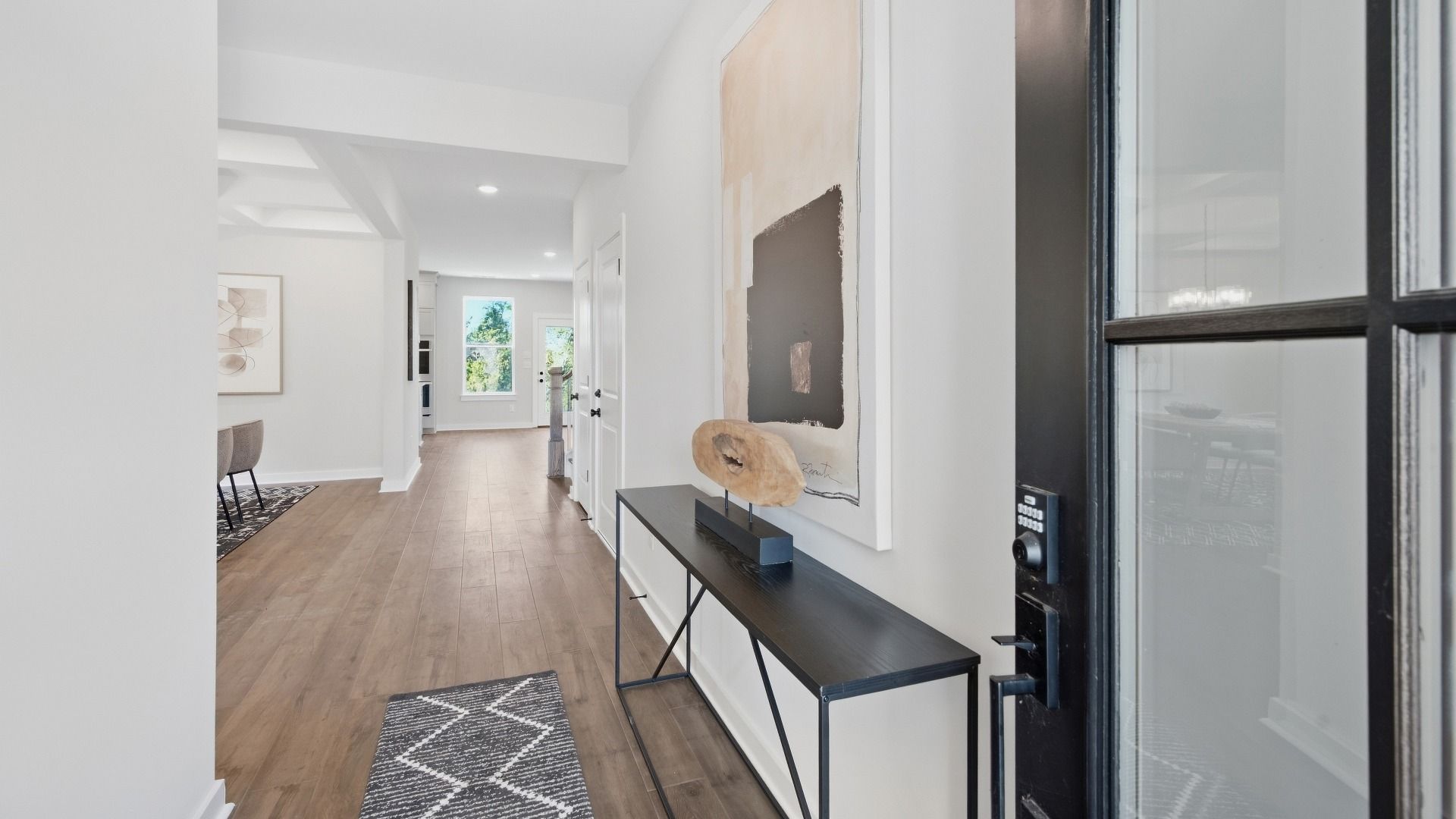 Front door entrance with spacious hallway and immediate versatile living space