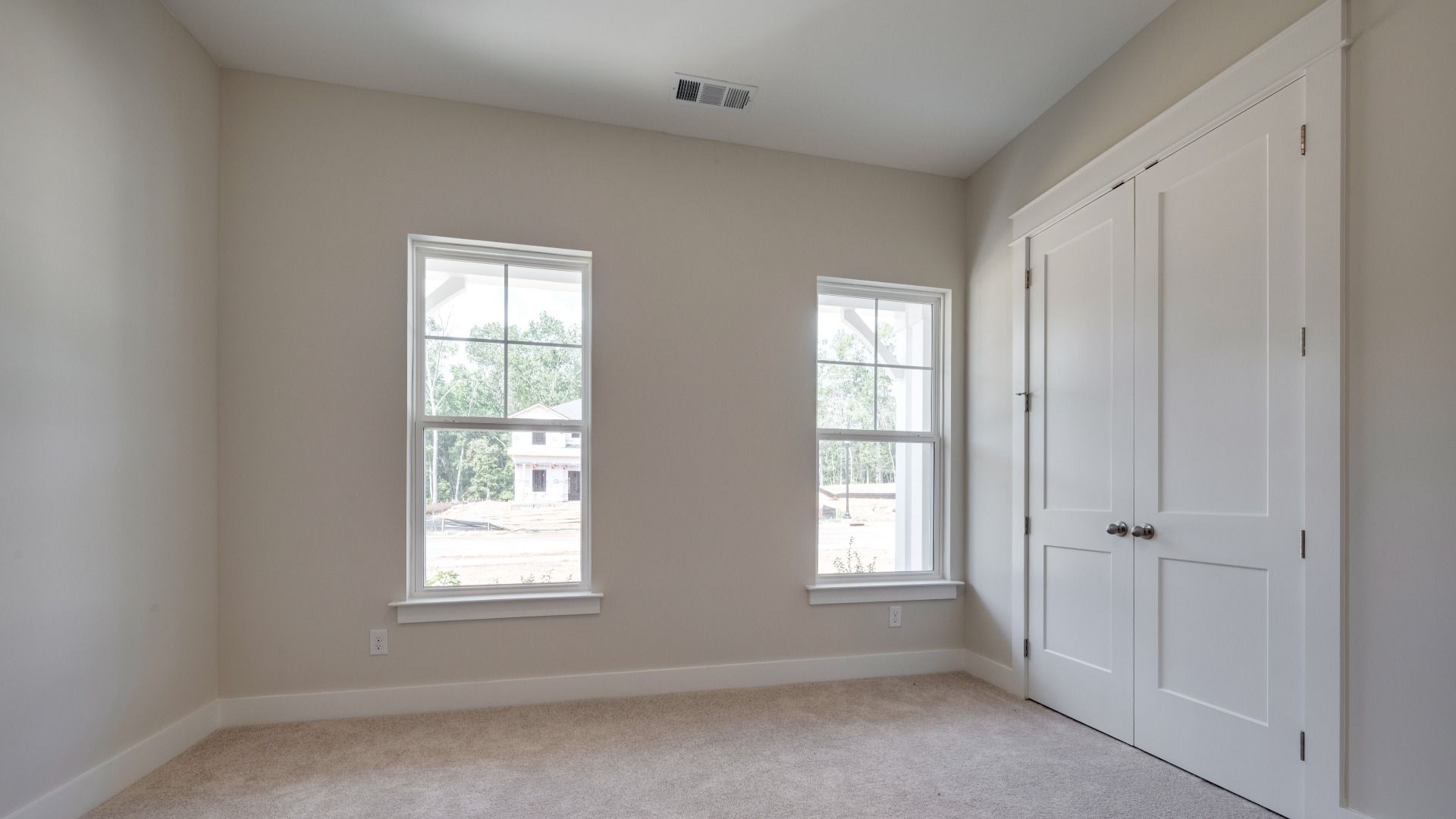 Secondary bedroom with double door closet next to front door