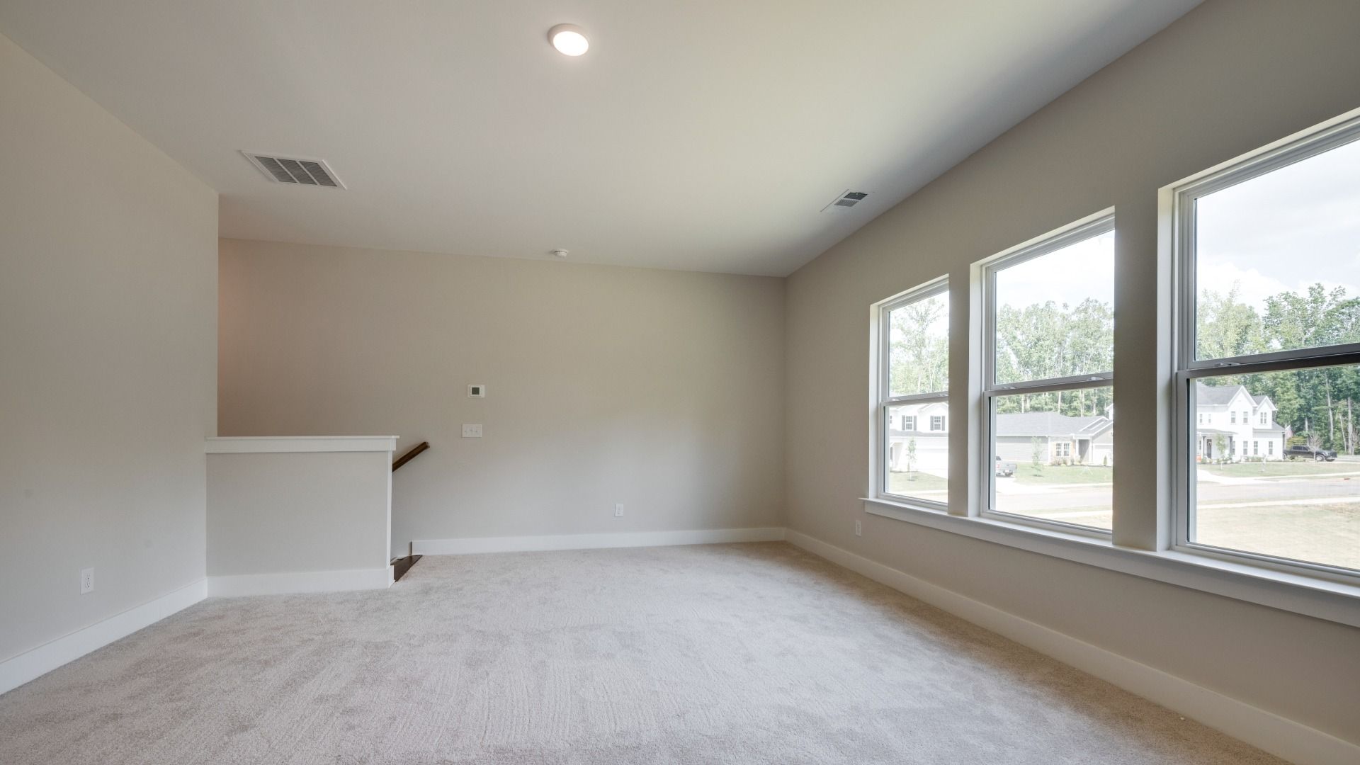 Versatile spacious upstairs bonus room with three windows