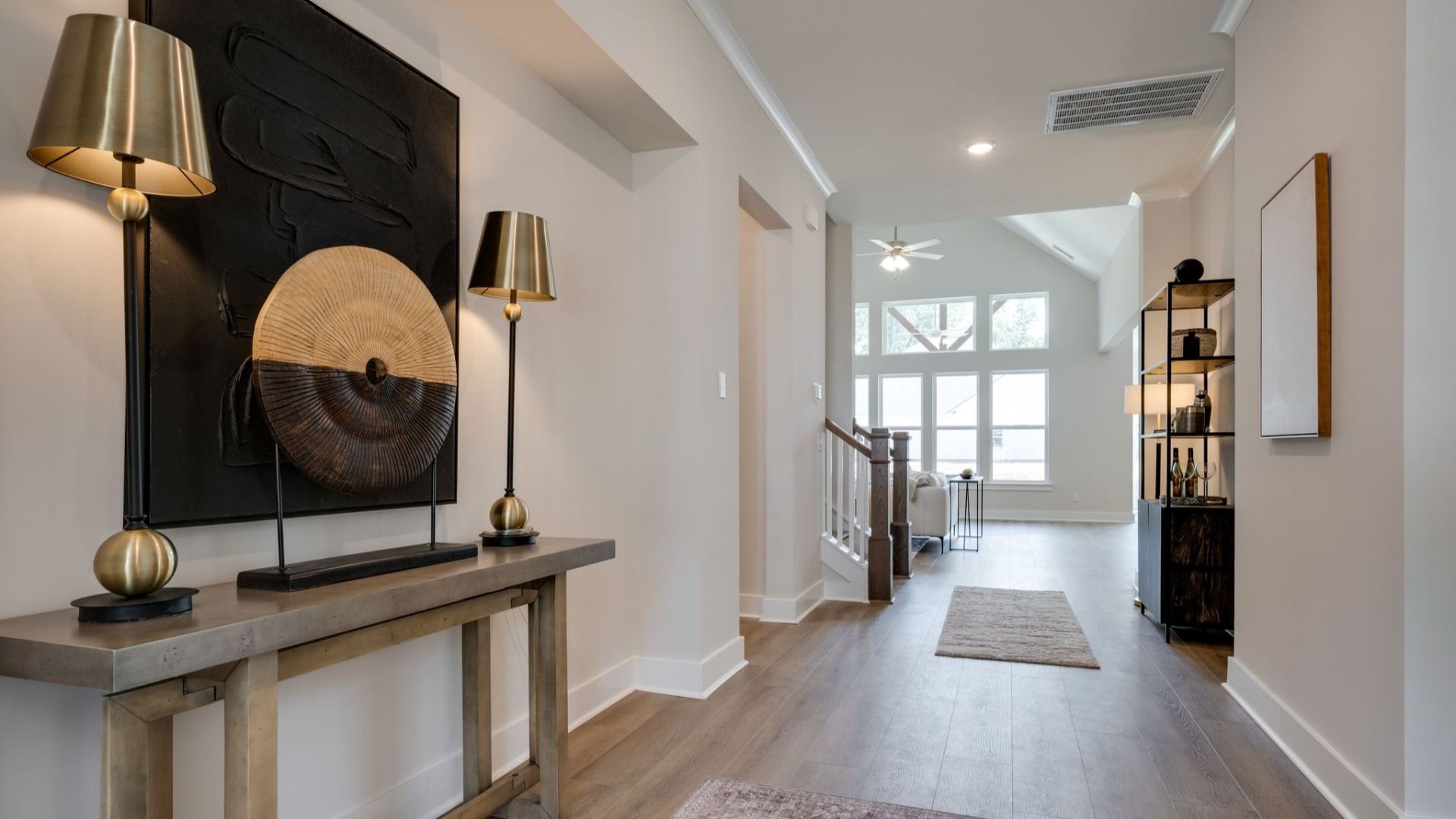 Front door leading into hallway with hardwood flooring
