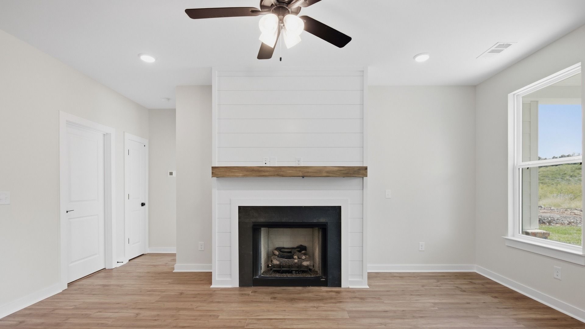 Gathering area with elevated features such as fireplace and ceiling fan