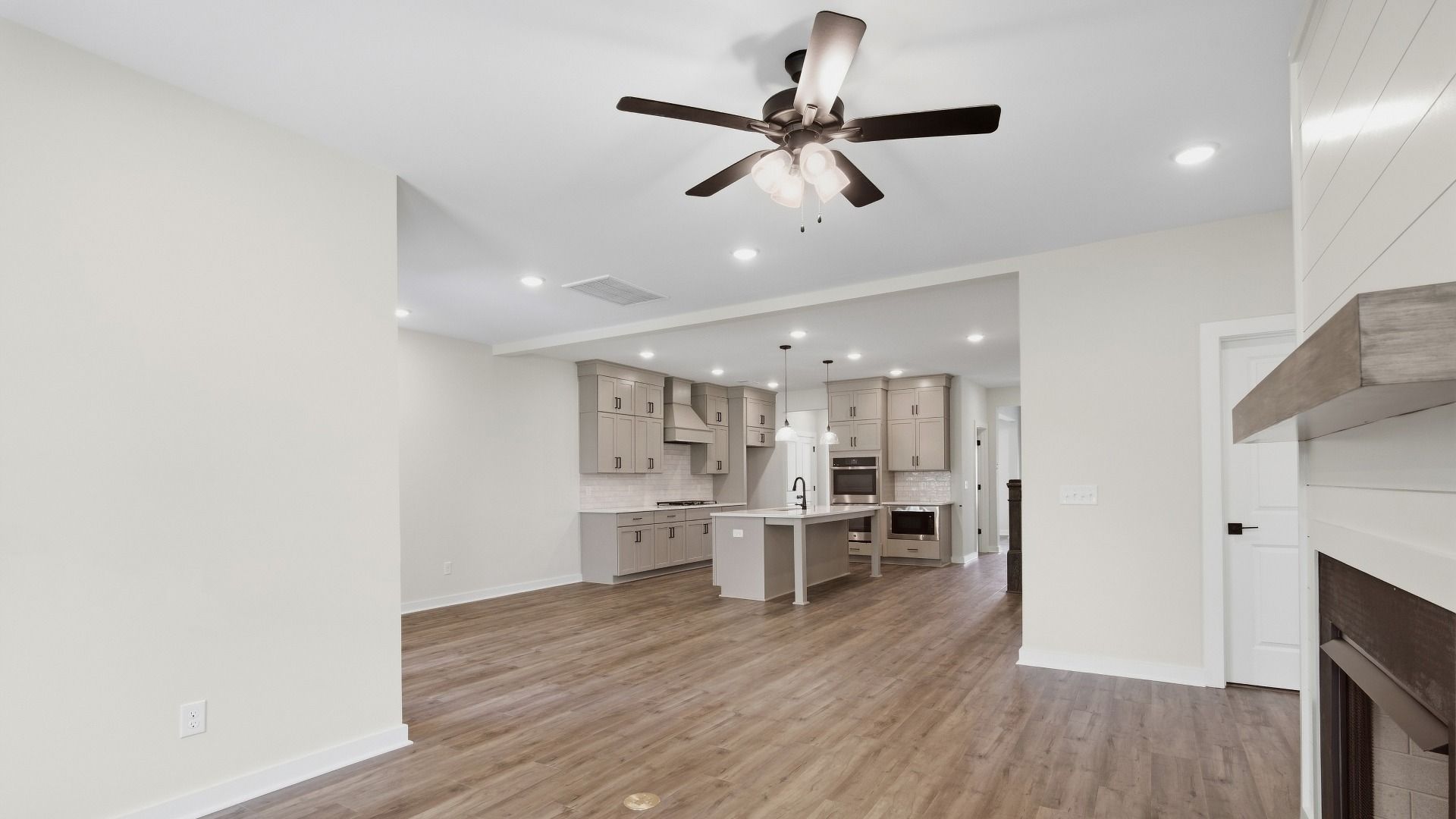 Modern light fixtures illuminate the living and dining areas