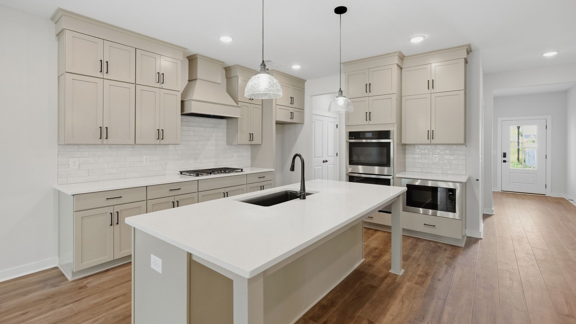 Kitchen featuring ceiling height cabinets, upgraded kitchen features, and optional butler's pantry included